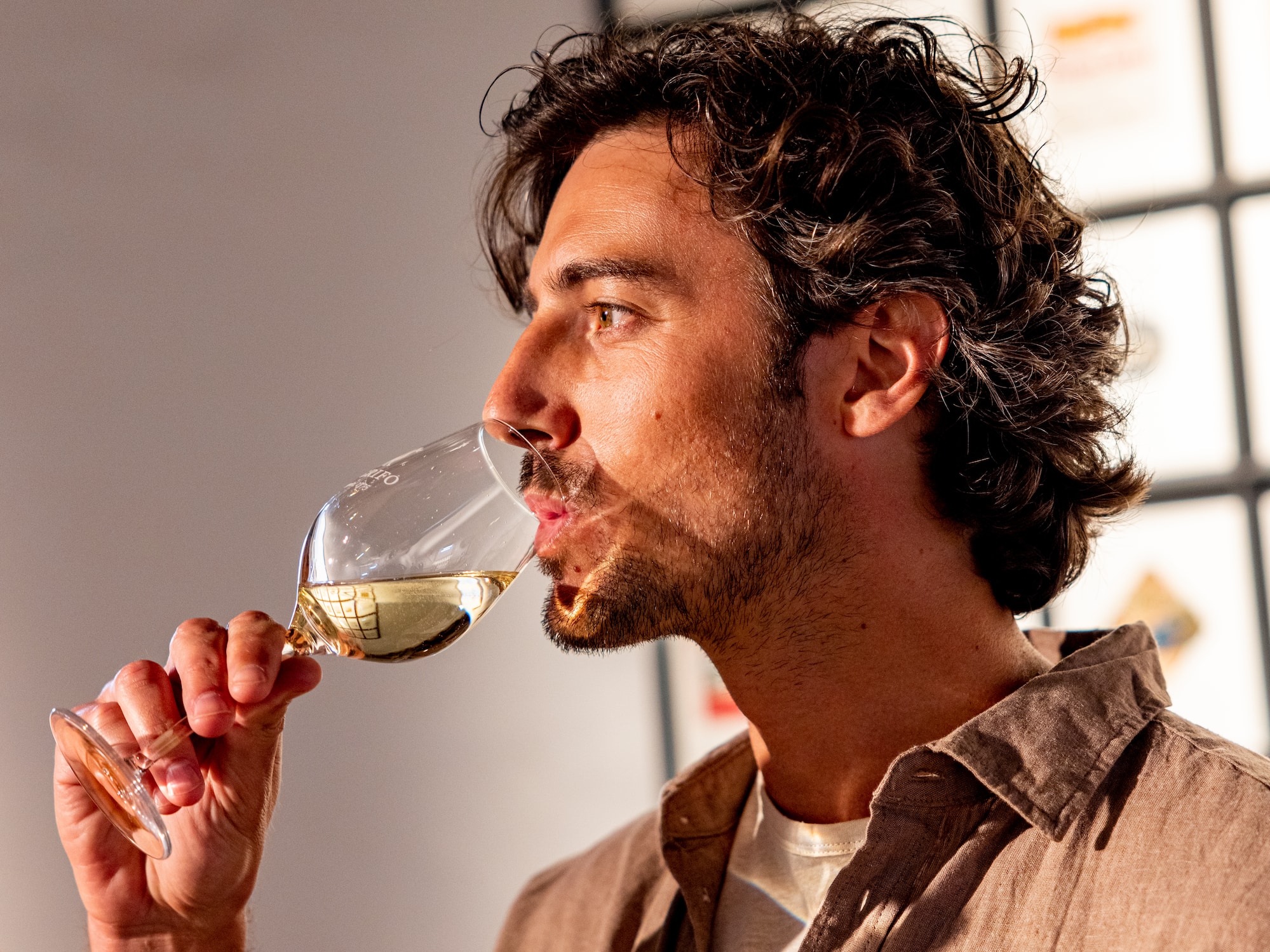 a man drinking from a wine glass