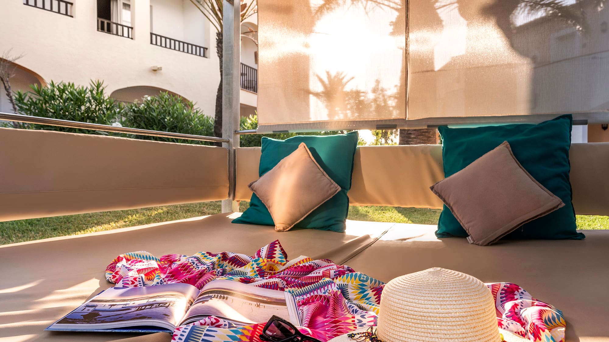 a sun lounger with a hat and a book on it