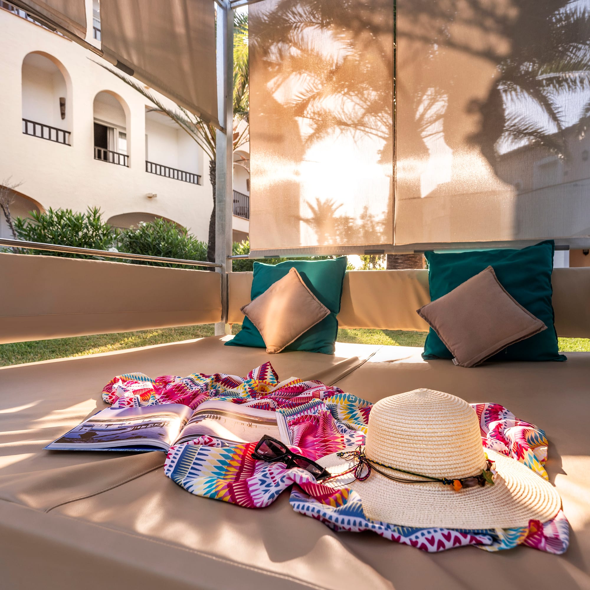 a sun lounger with a hat and a book on it