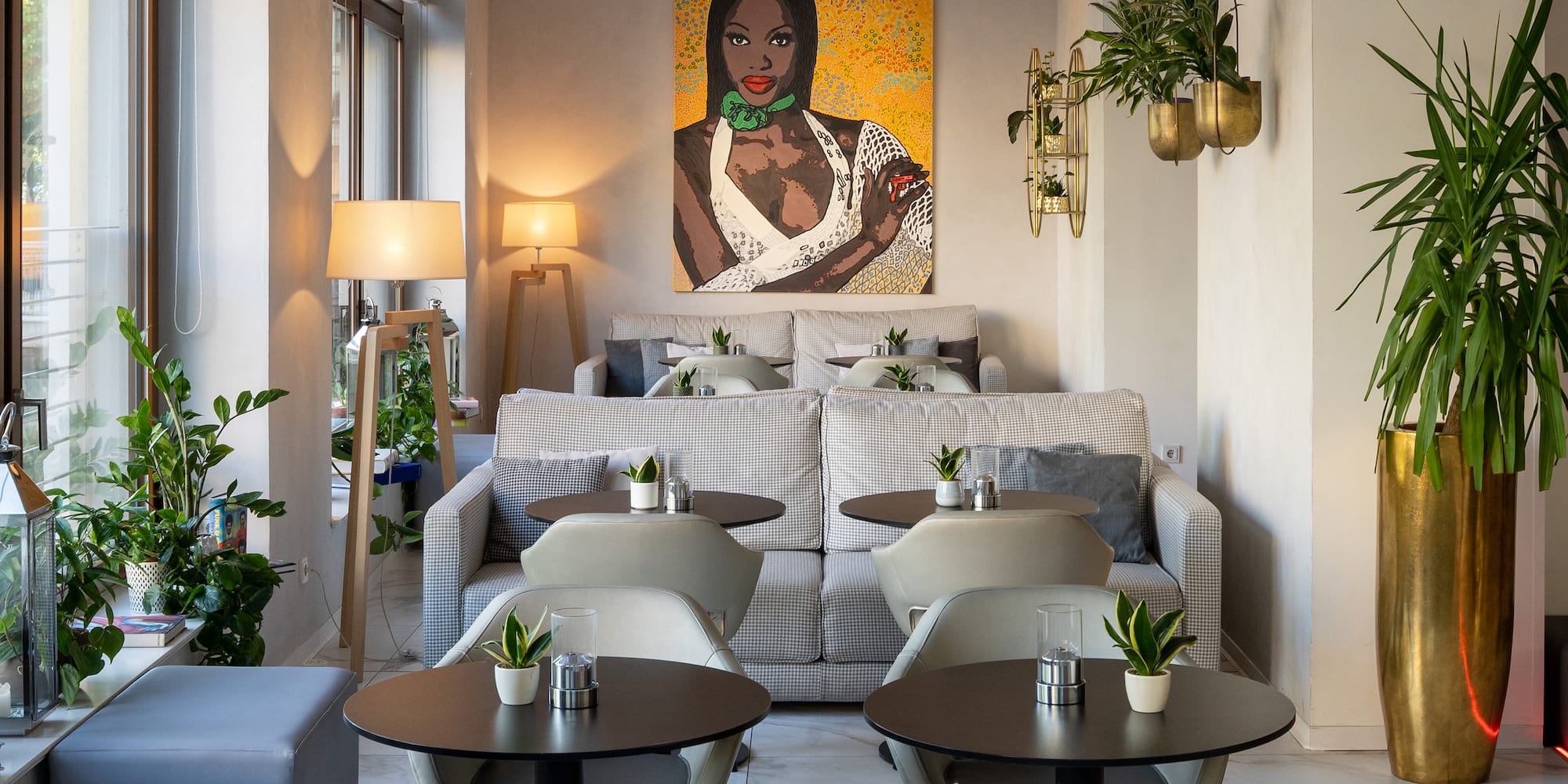 a room with tables and chairs and a painting on the wall