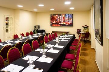 a room with a long table and chairs