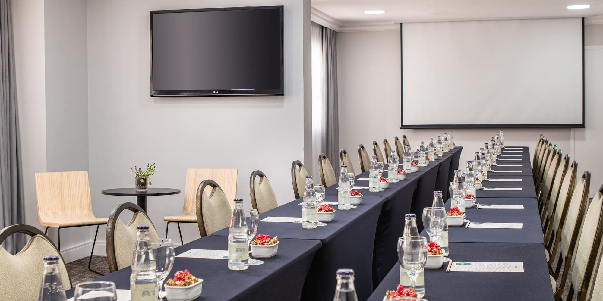 a long table with drinks and glasses on it
