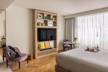 a room with a bed and a tv