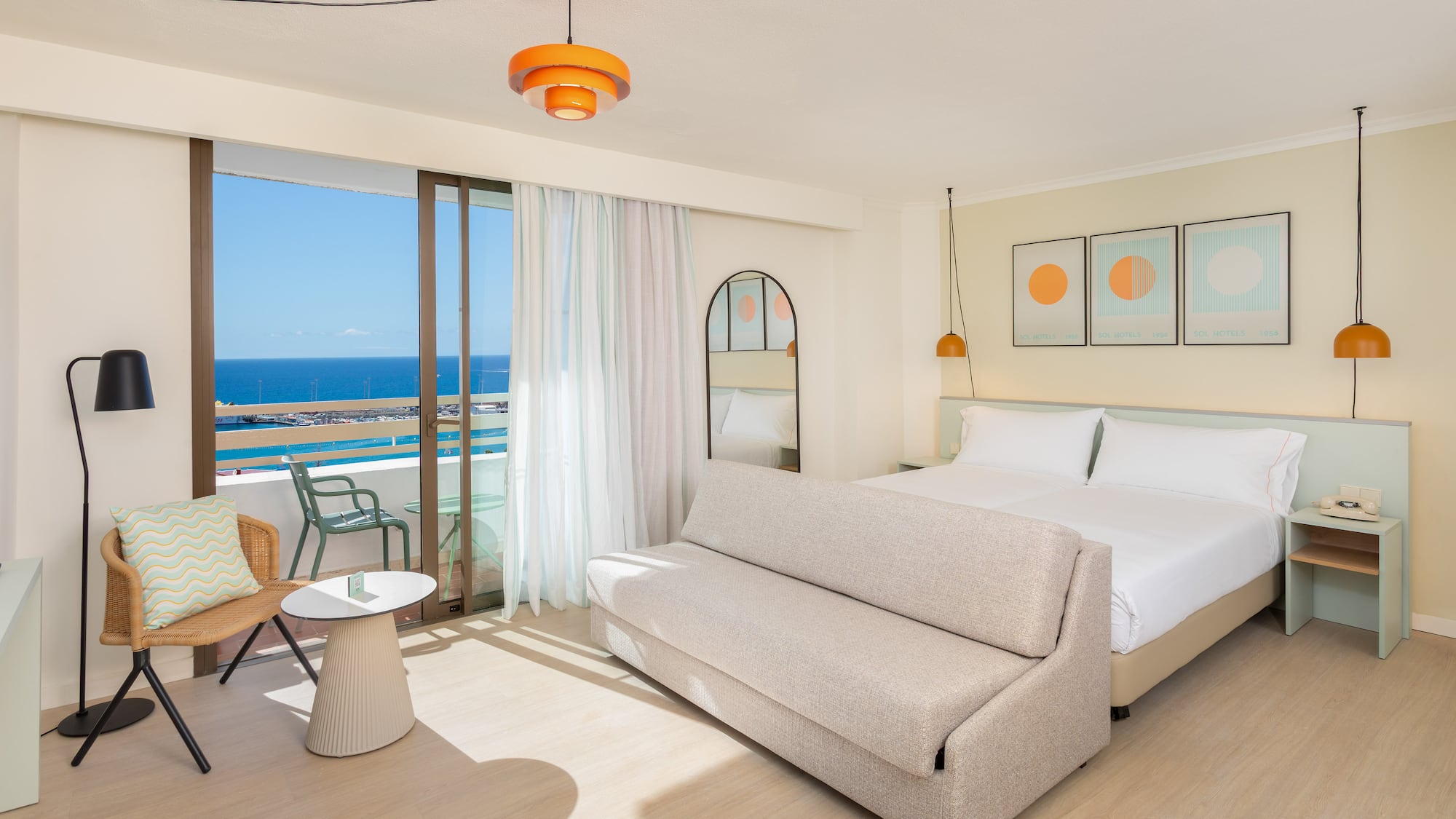 a room with a bed and a chair and a table
