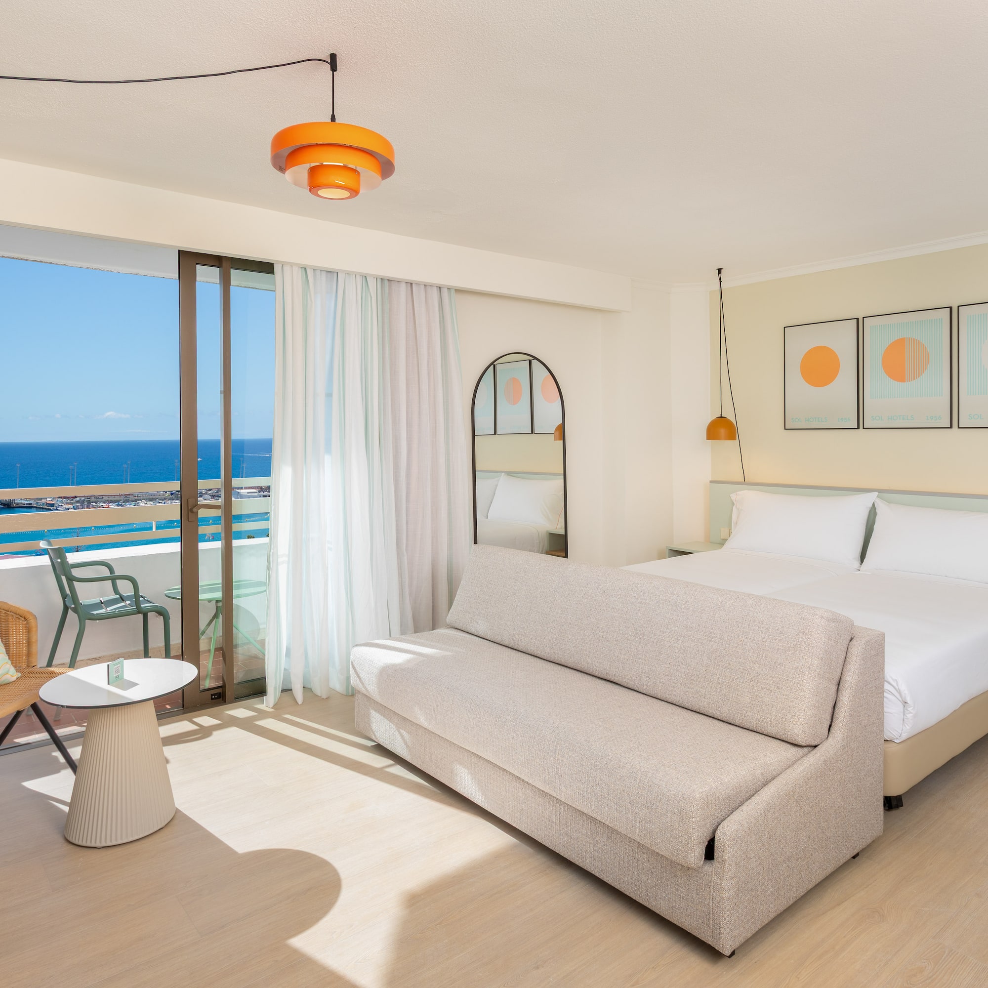 a room with a bed and a chair and a table