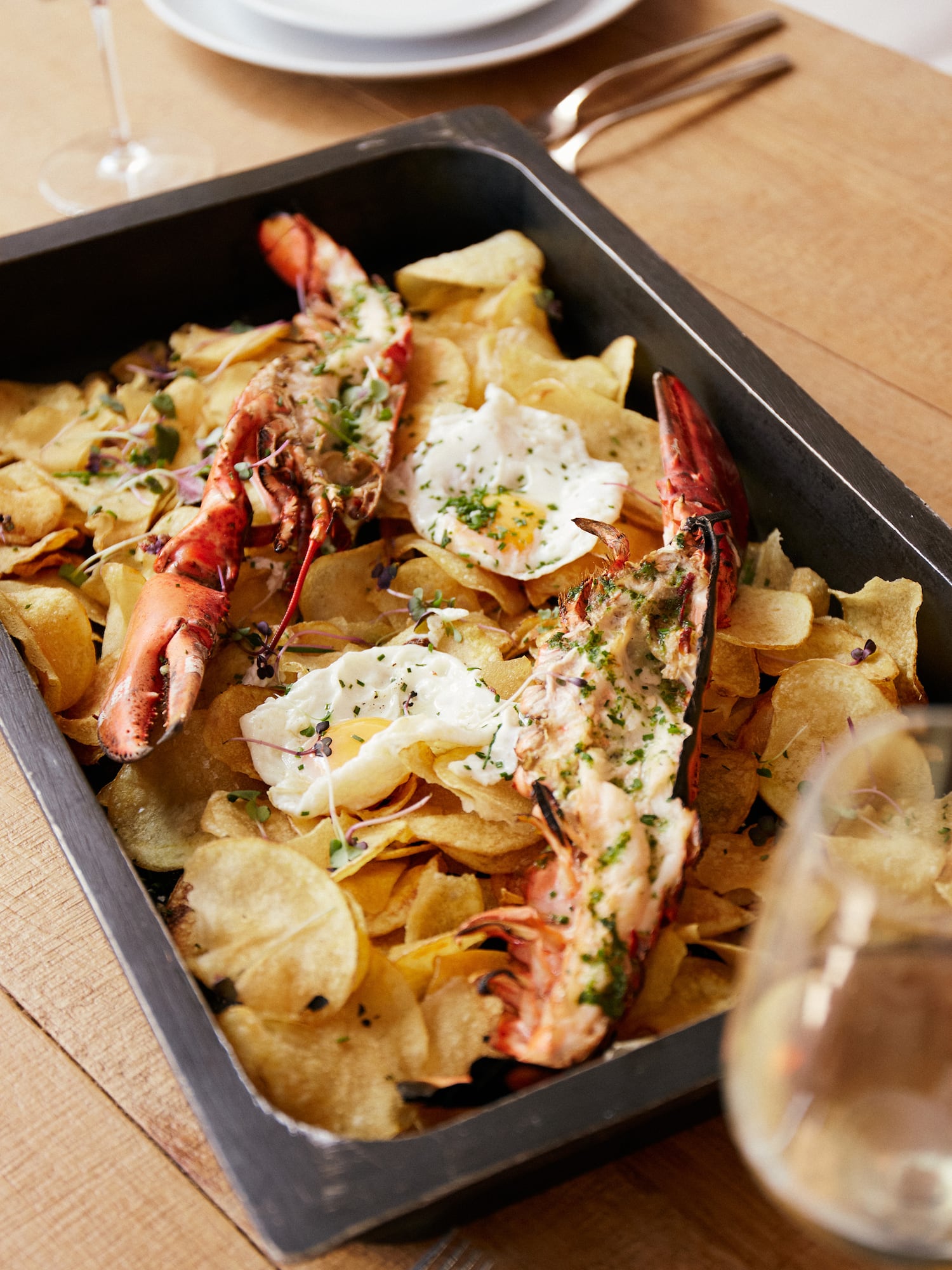 a plate of food with lobsters and potato chips