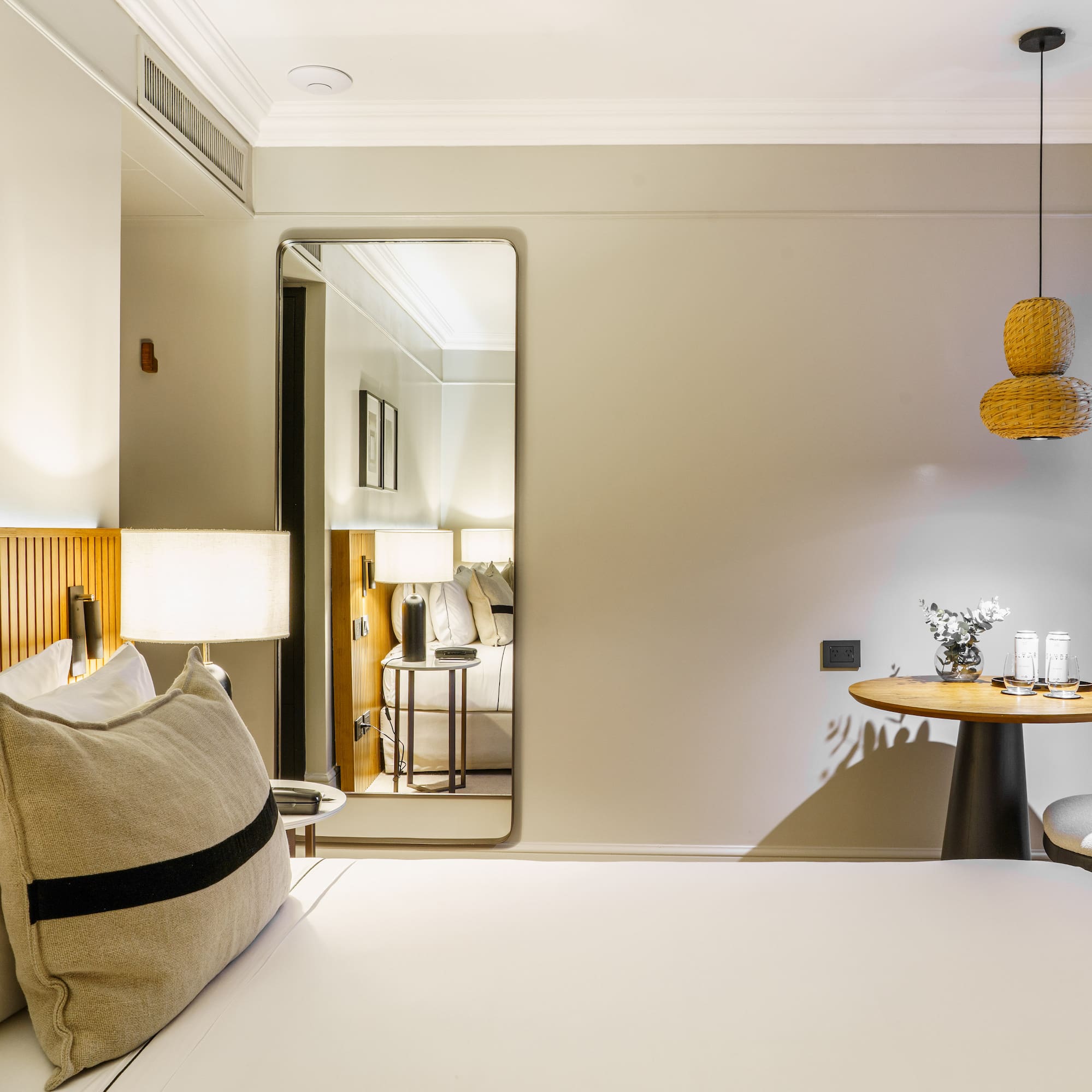 a bedroom with a round table and a lamp