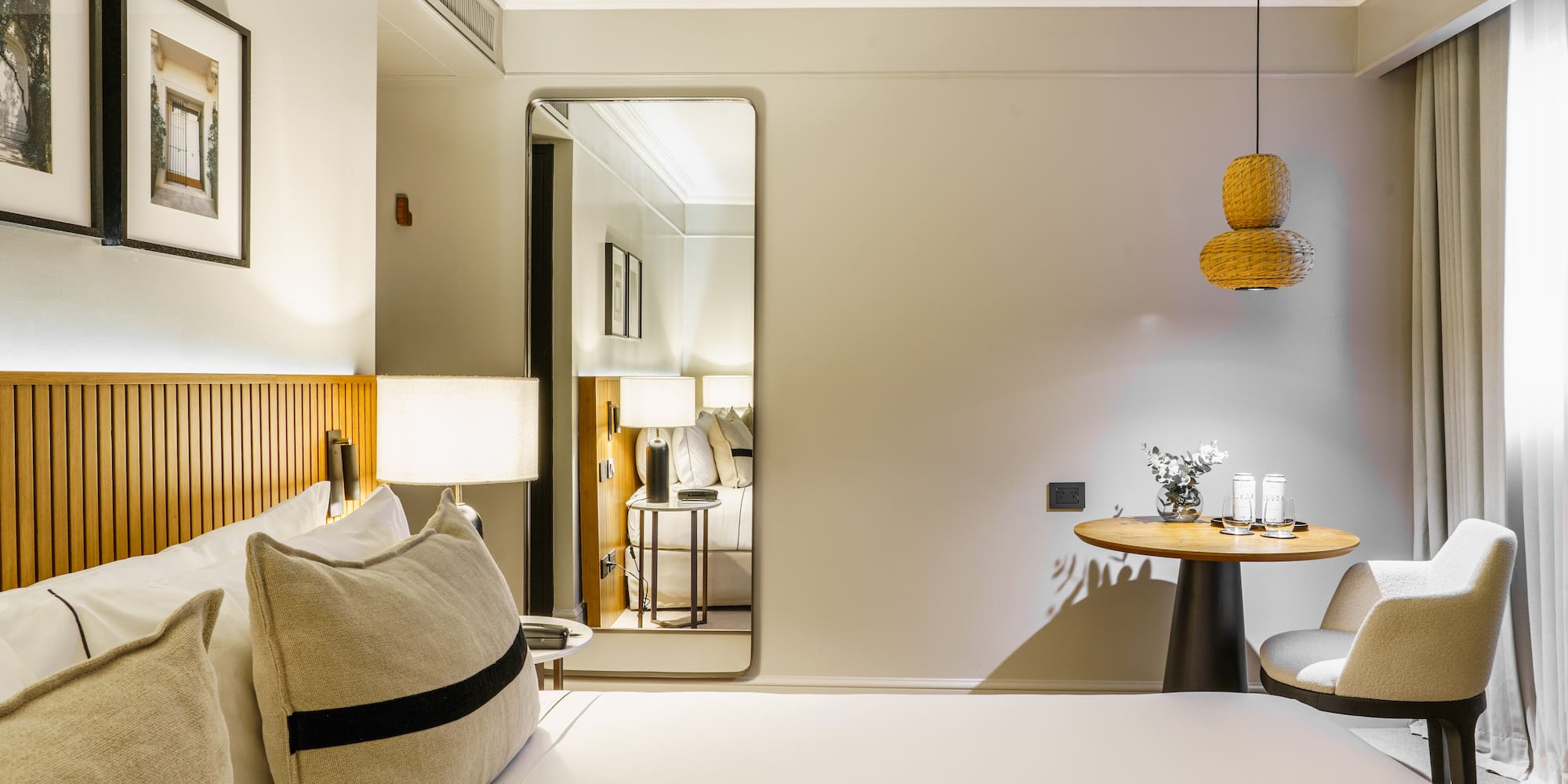 a bedroom with a round table and a lamp