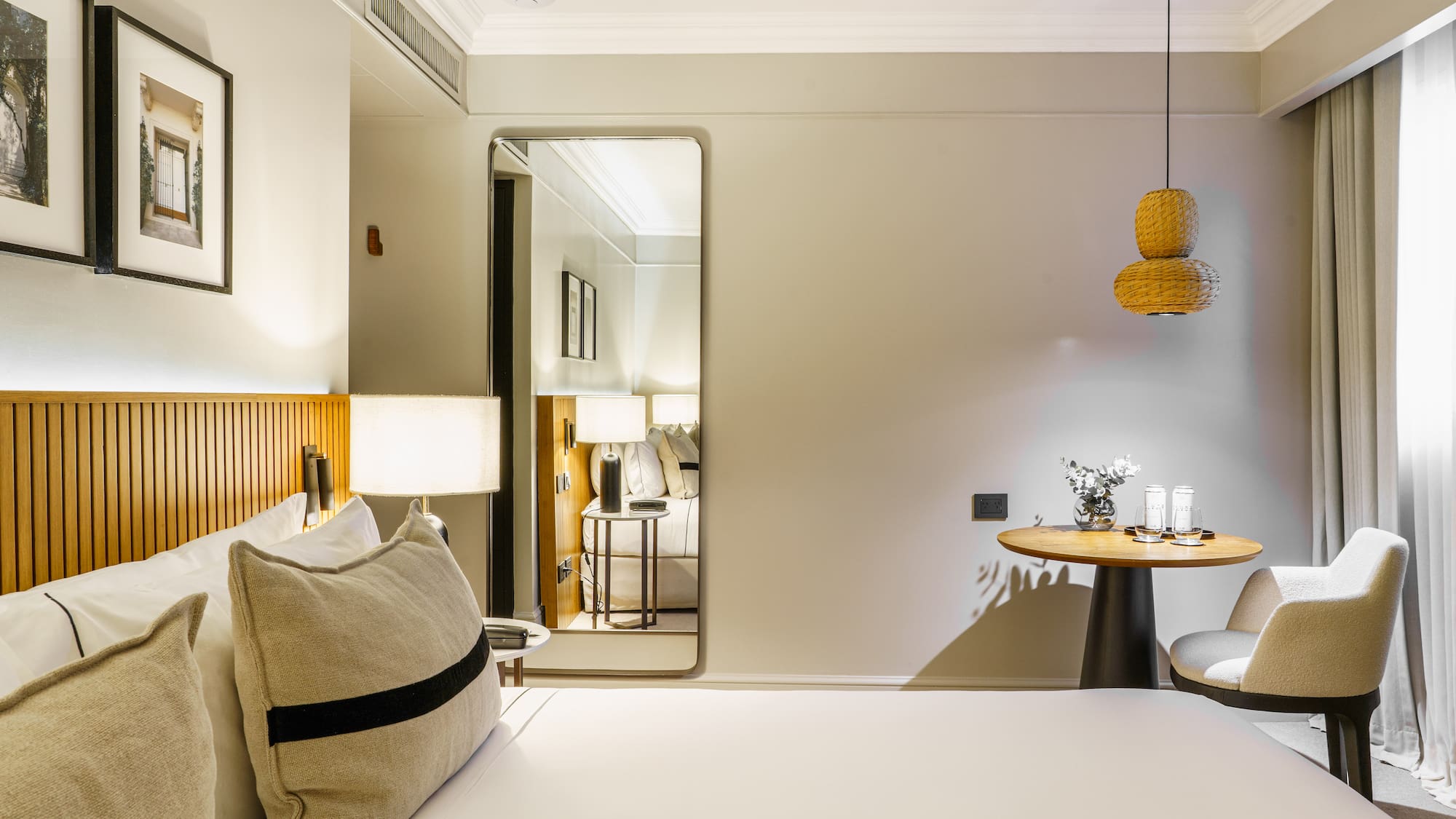 a bedroom with a round table and a lamp