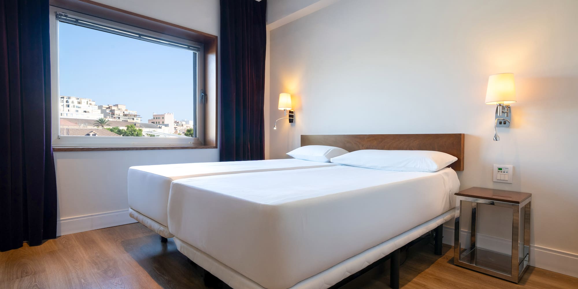 a room with two beds and a window