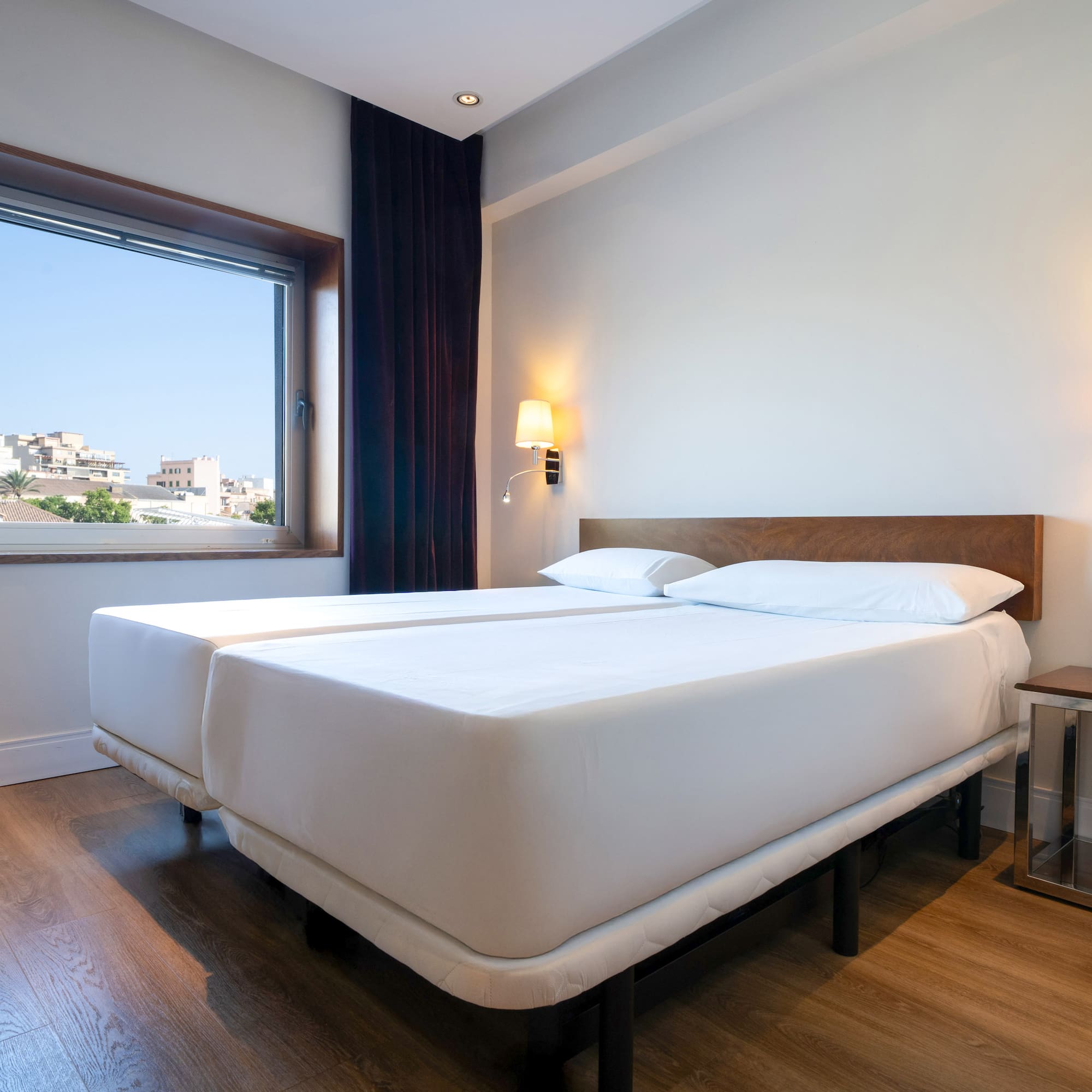 a room with two beds and a window