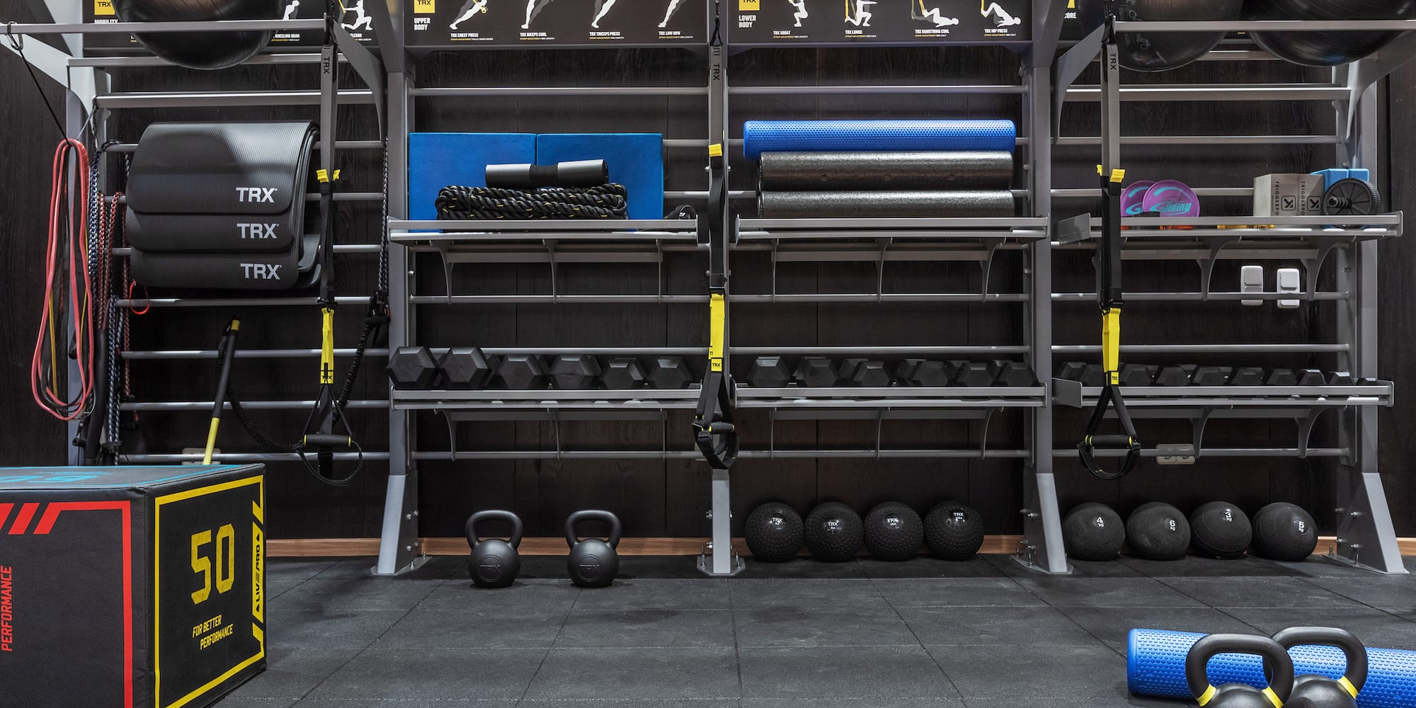 Gym with TRX, kettlebells, dumbbells, and functional fitness equipment.