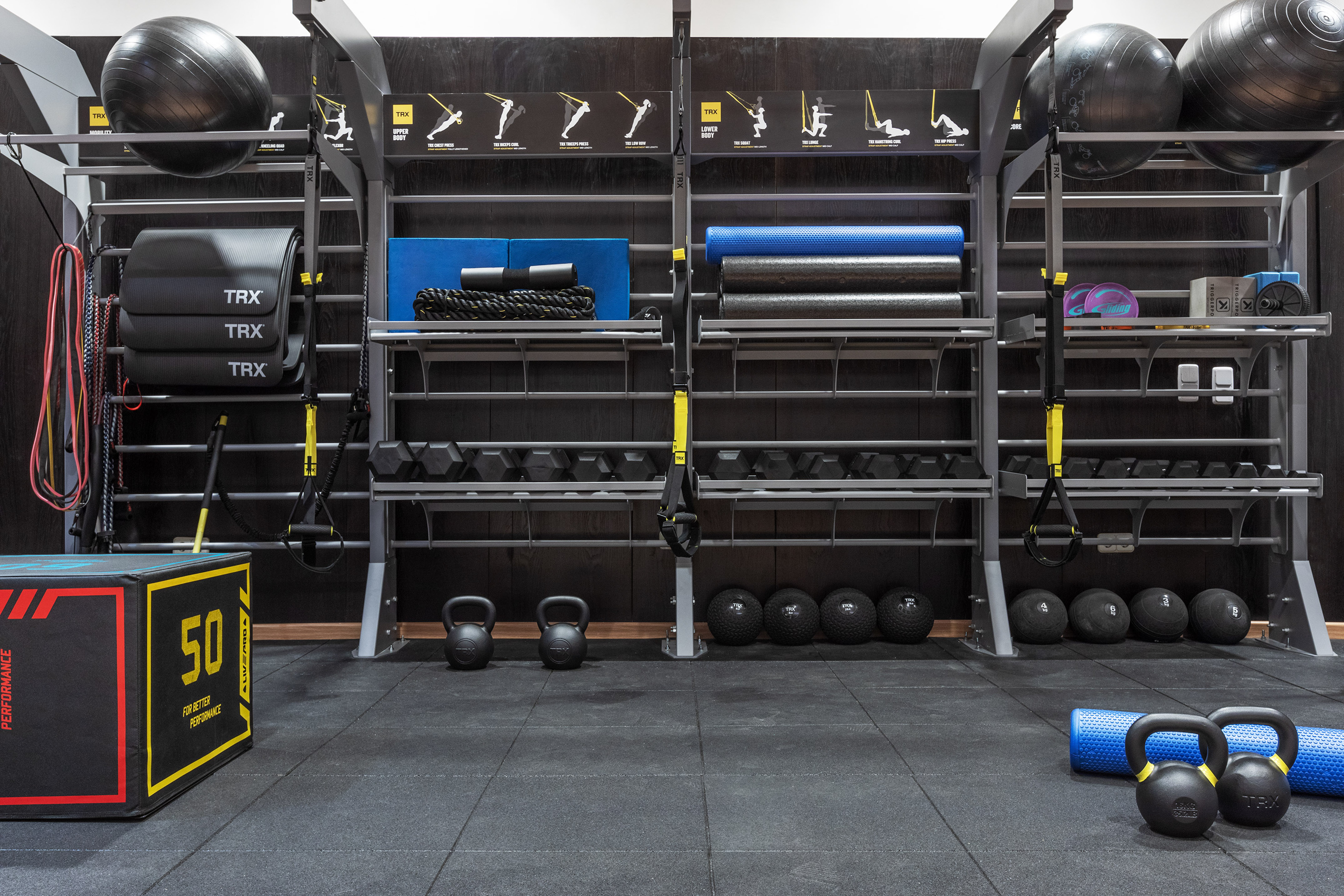 Gym with TRX, kettlebells, dumbbells, and functional fitness equipment.