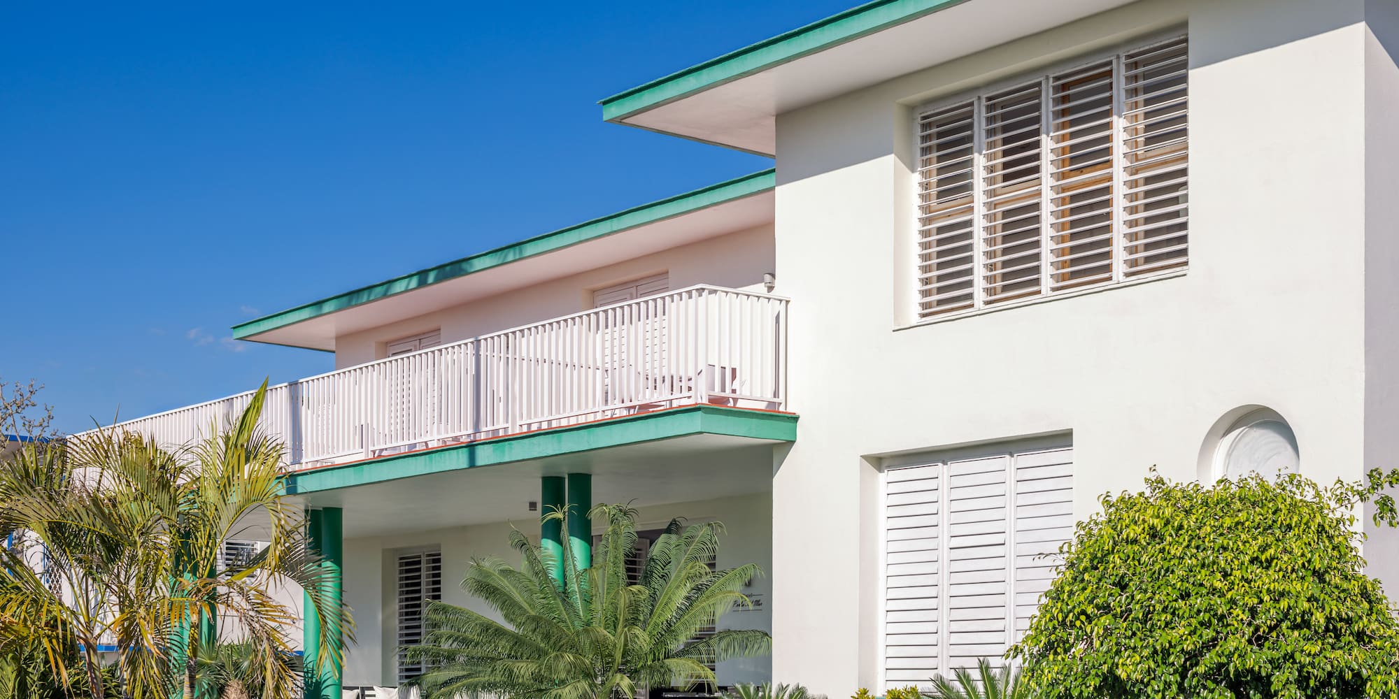 a white building with green trim