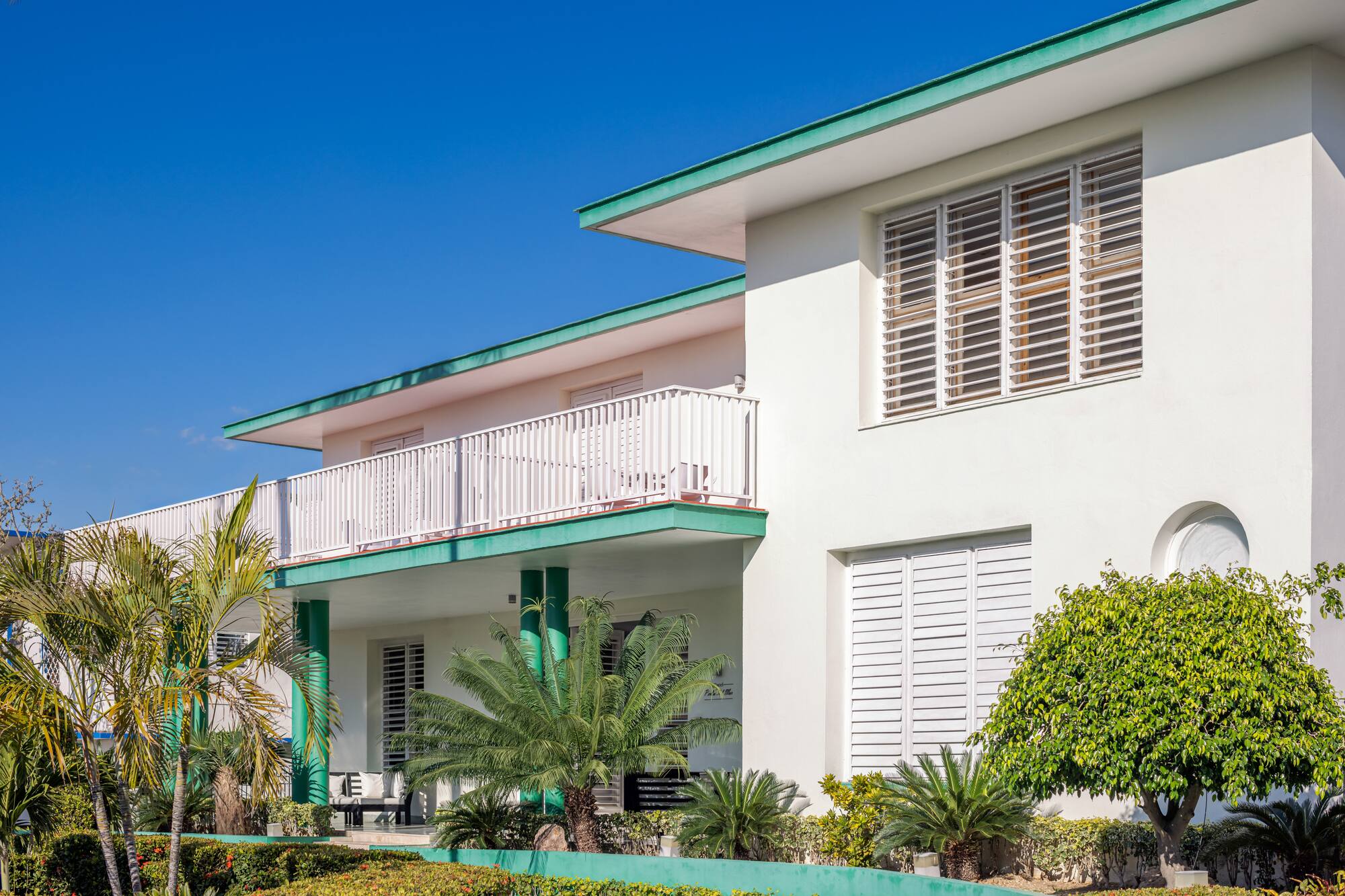 a white building with green trim