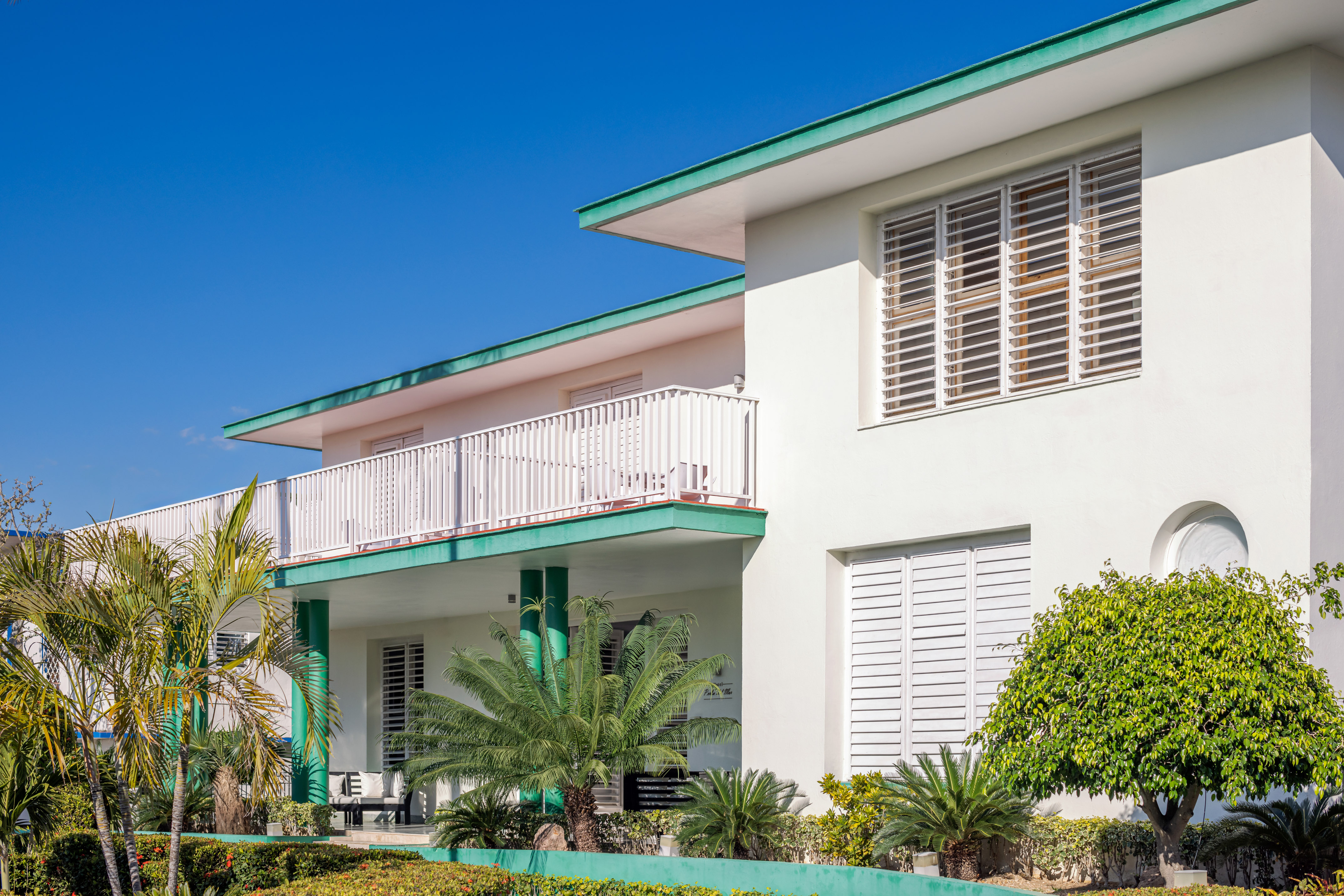 a white building with green trim