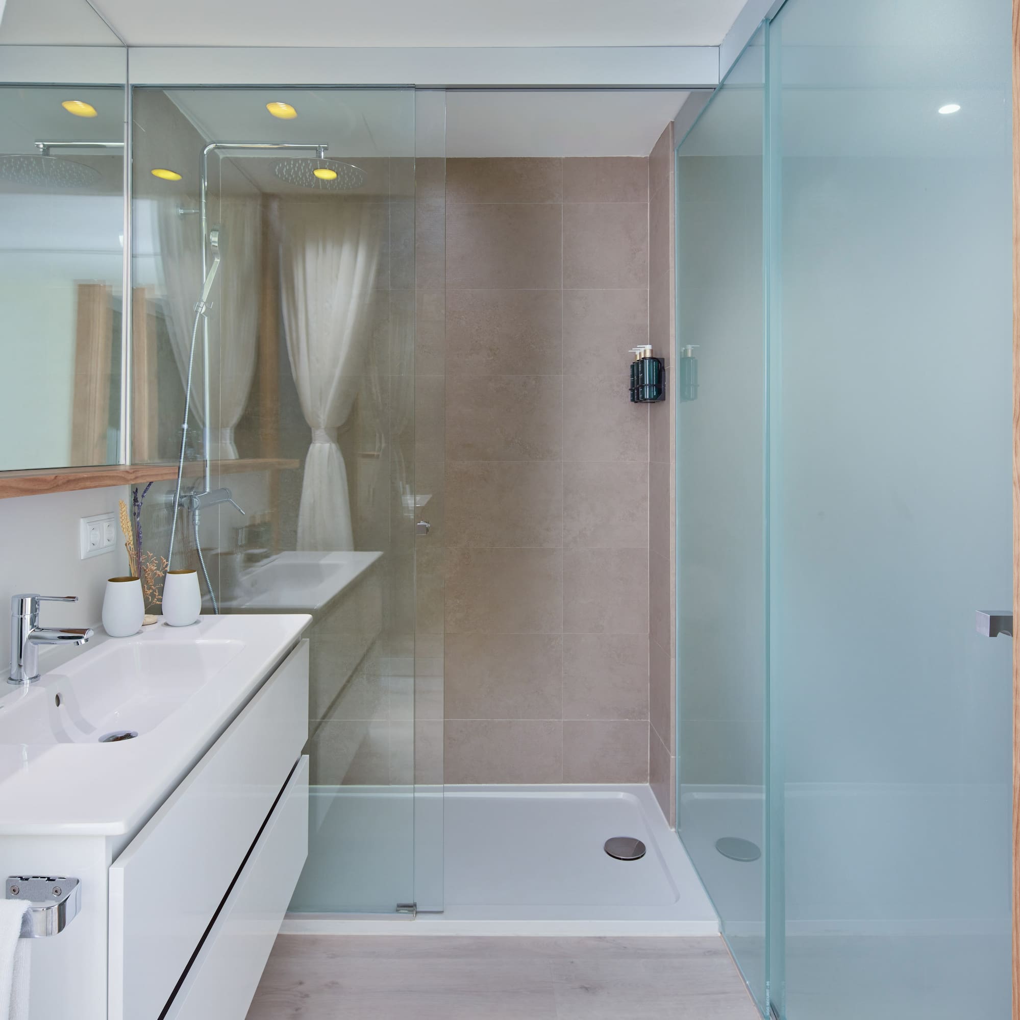 a bathroom with a glass shower and sink