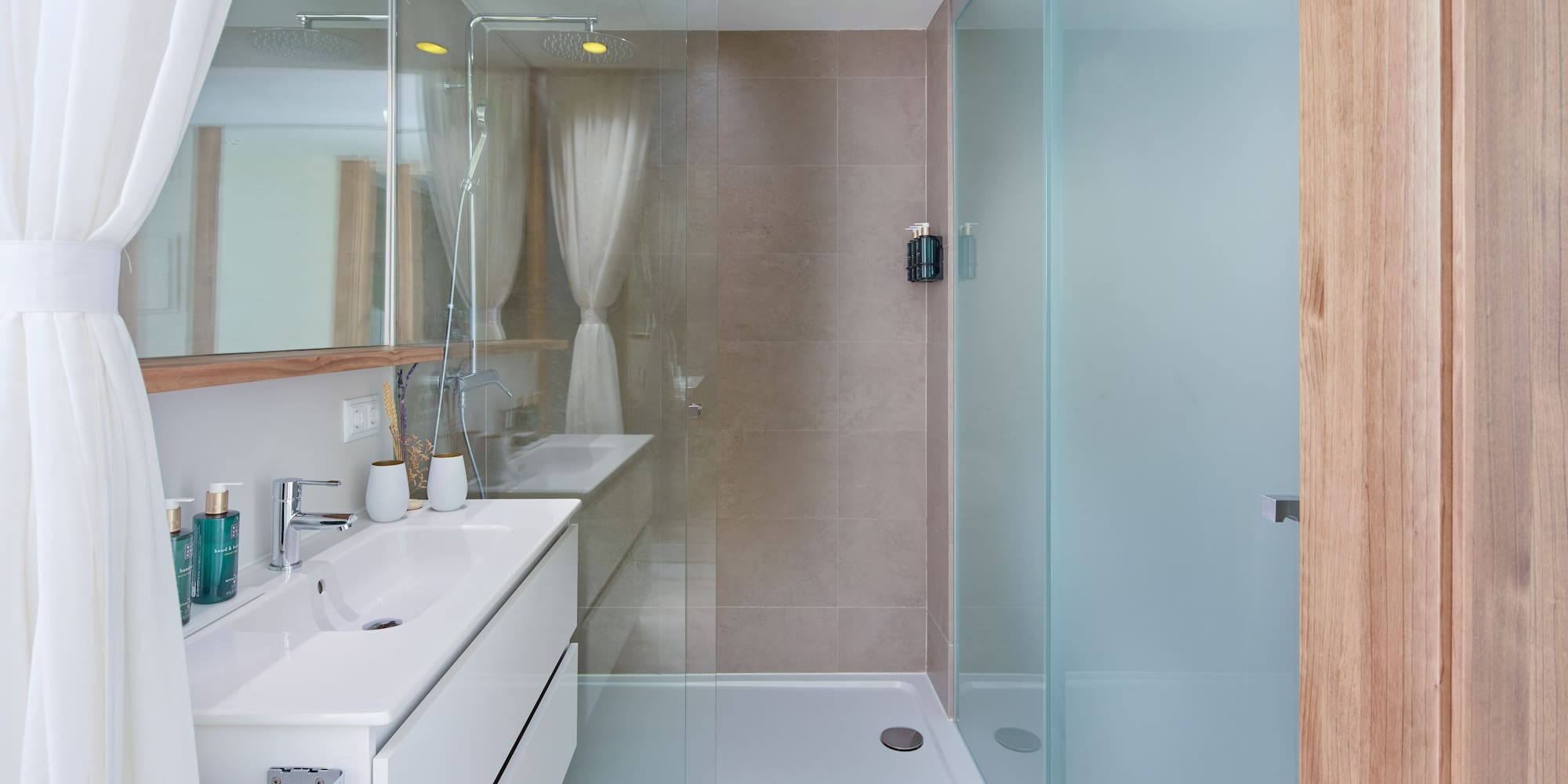 a bathroom with a glass shower and sink