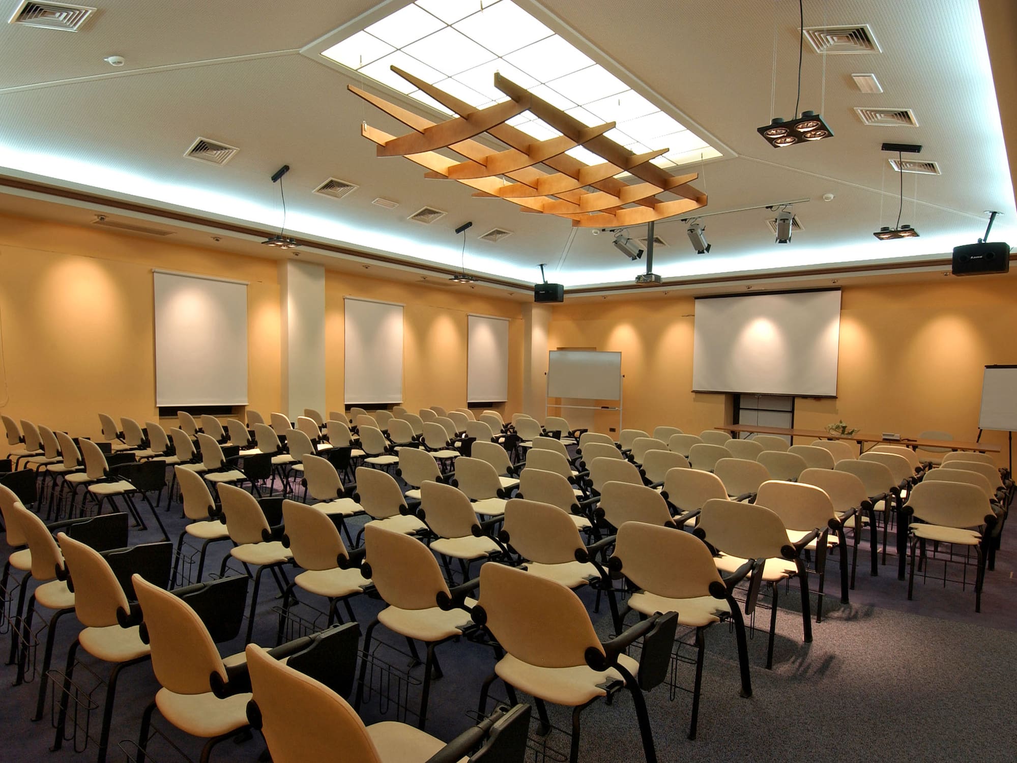a room with many chairs and a projector screen