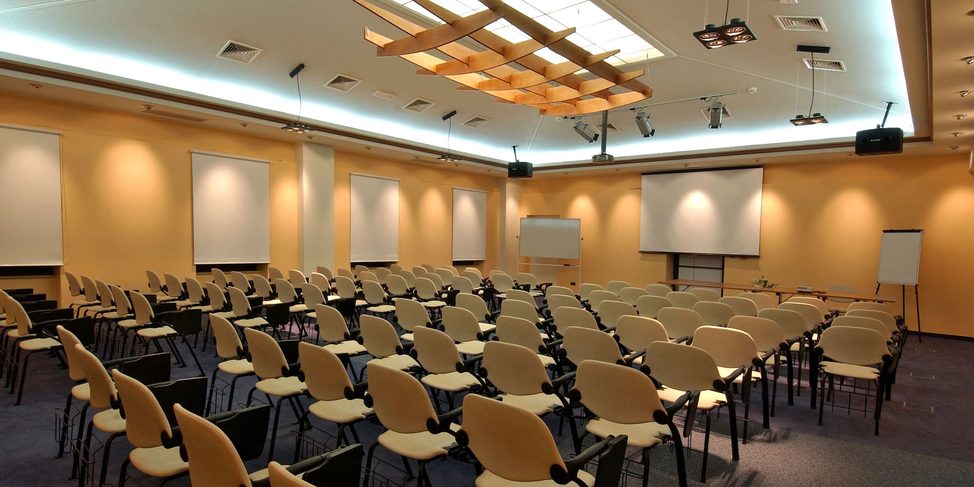 a room with many chairs and a projector screen