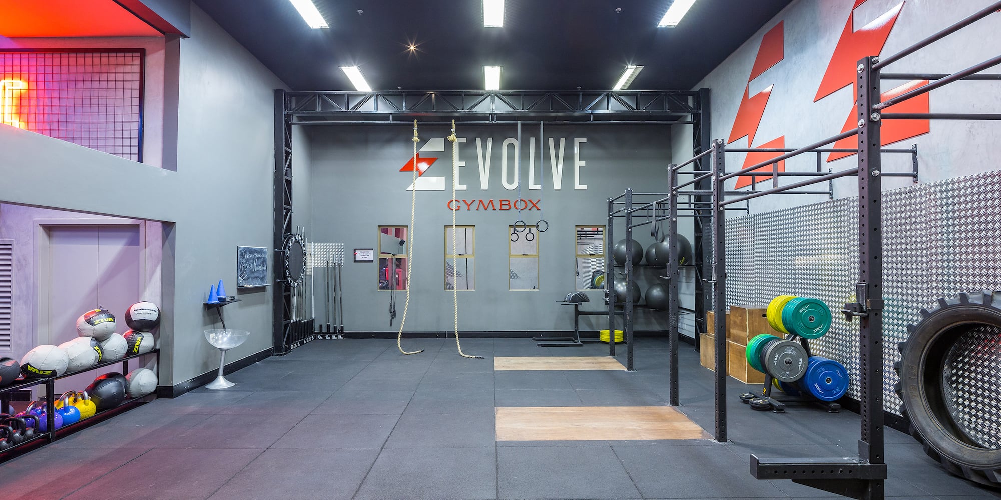 a gym with a large room with a wall and a gym equipment