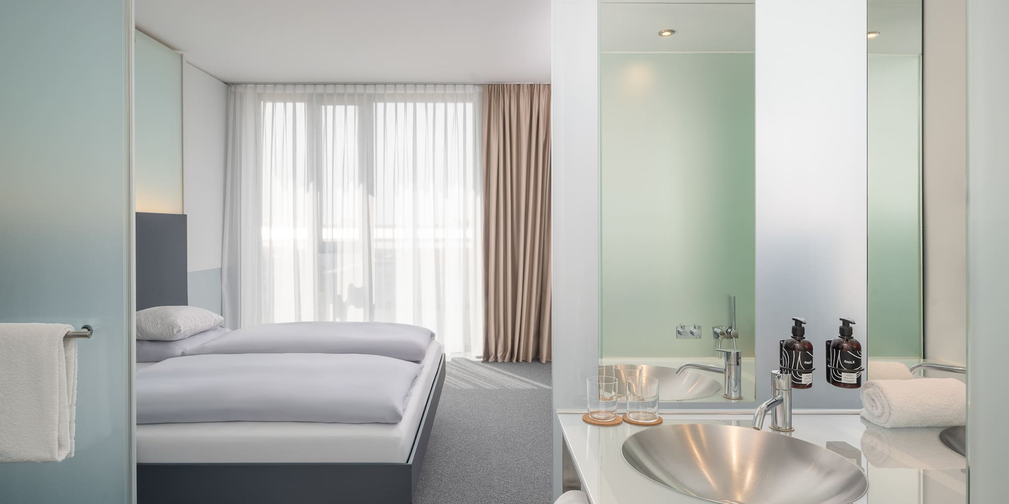 a bathroom with a bed and sink