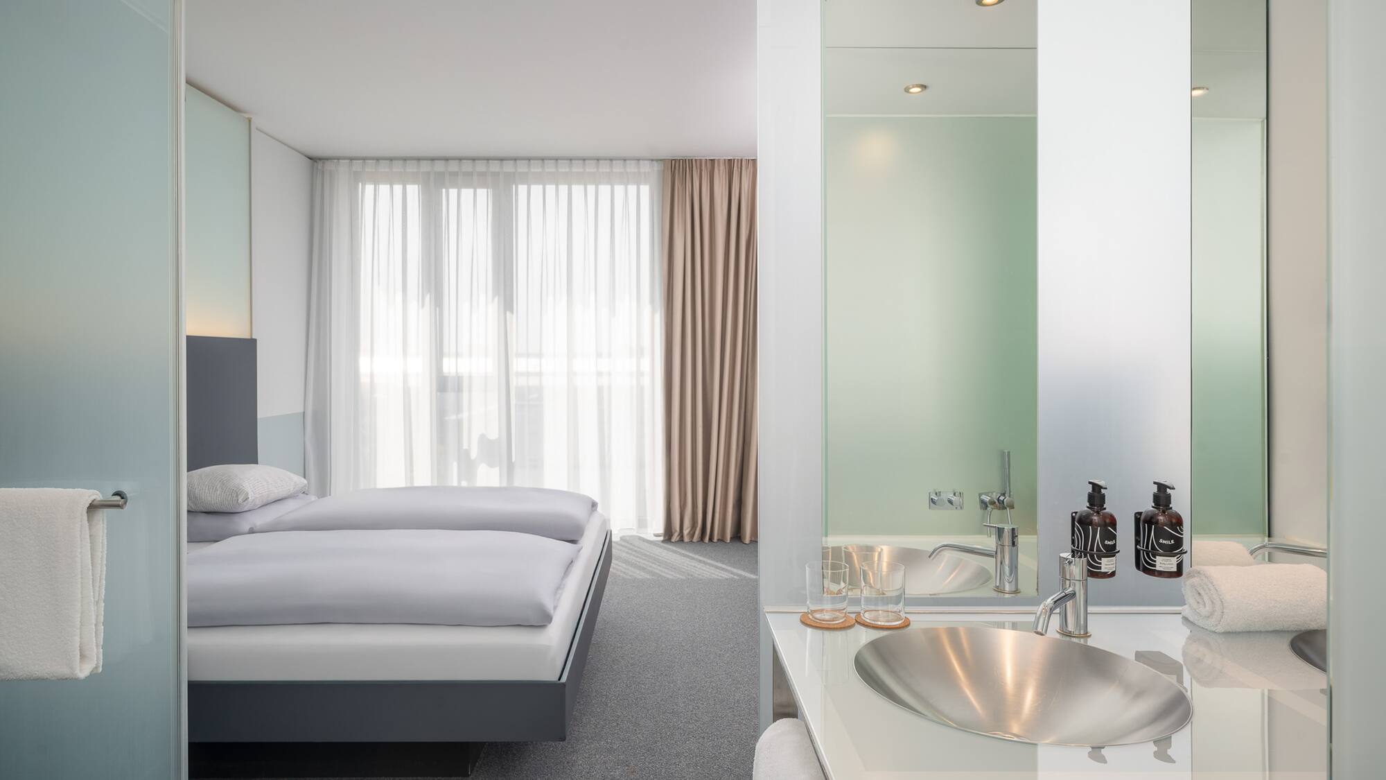 a bathroom with a bed and sink