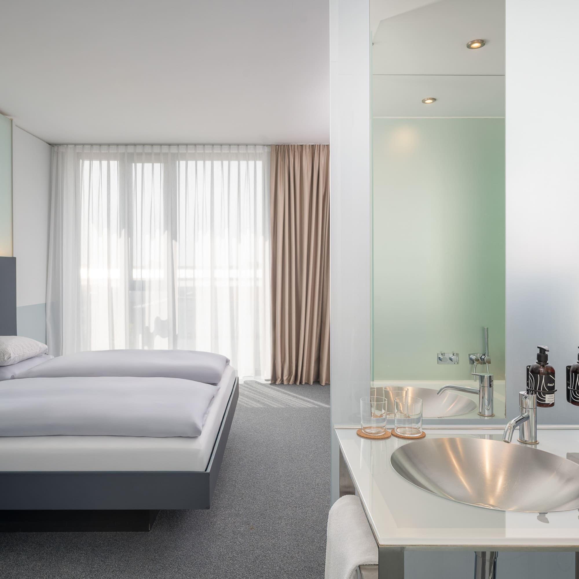 a bathroom with a bed and sink