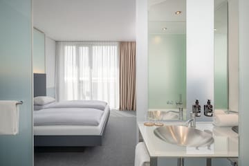 a bathroom with a bed and sink