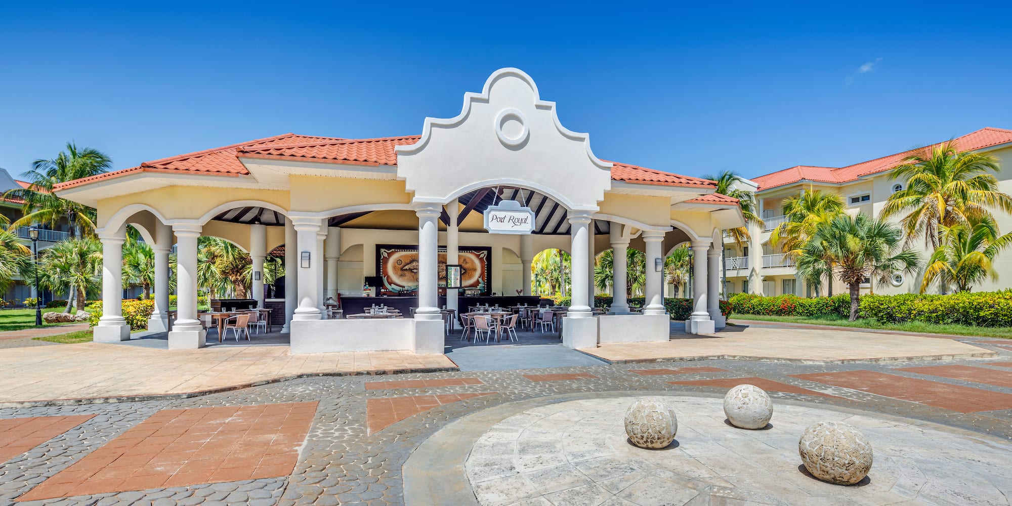 a building with columns and a round stone circle