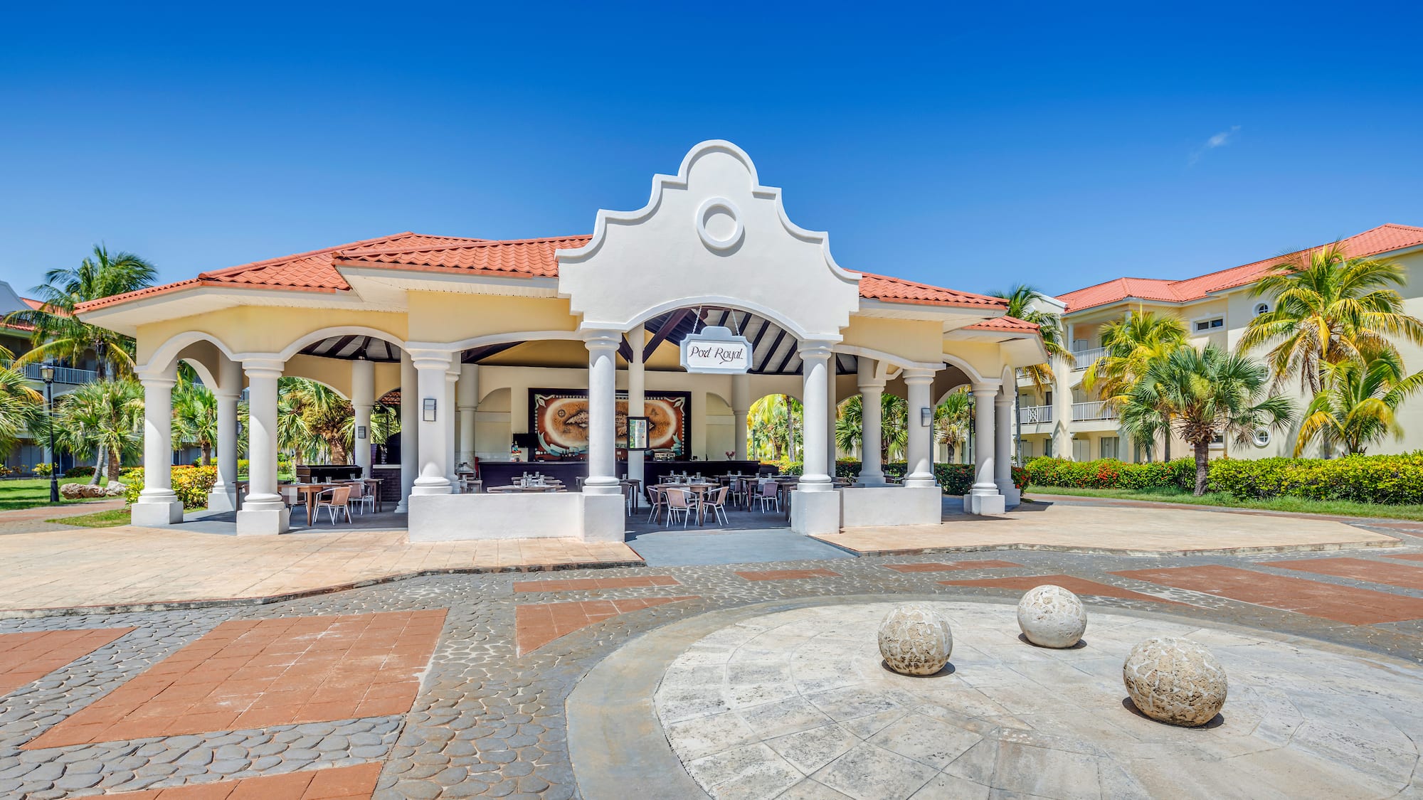 a building with columns and a round stone circle