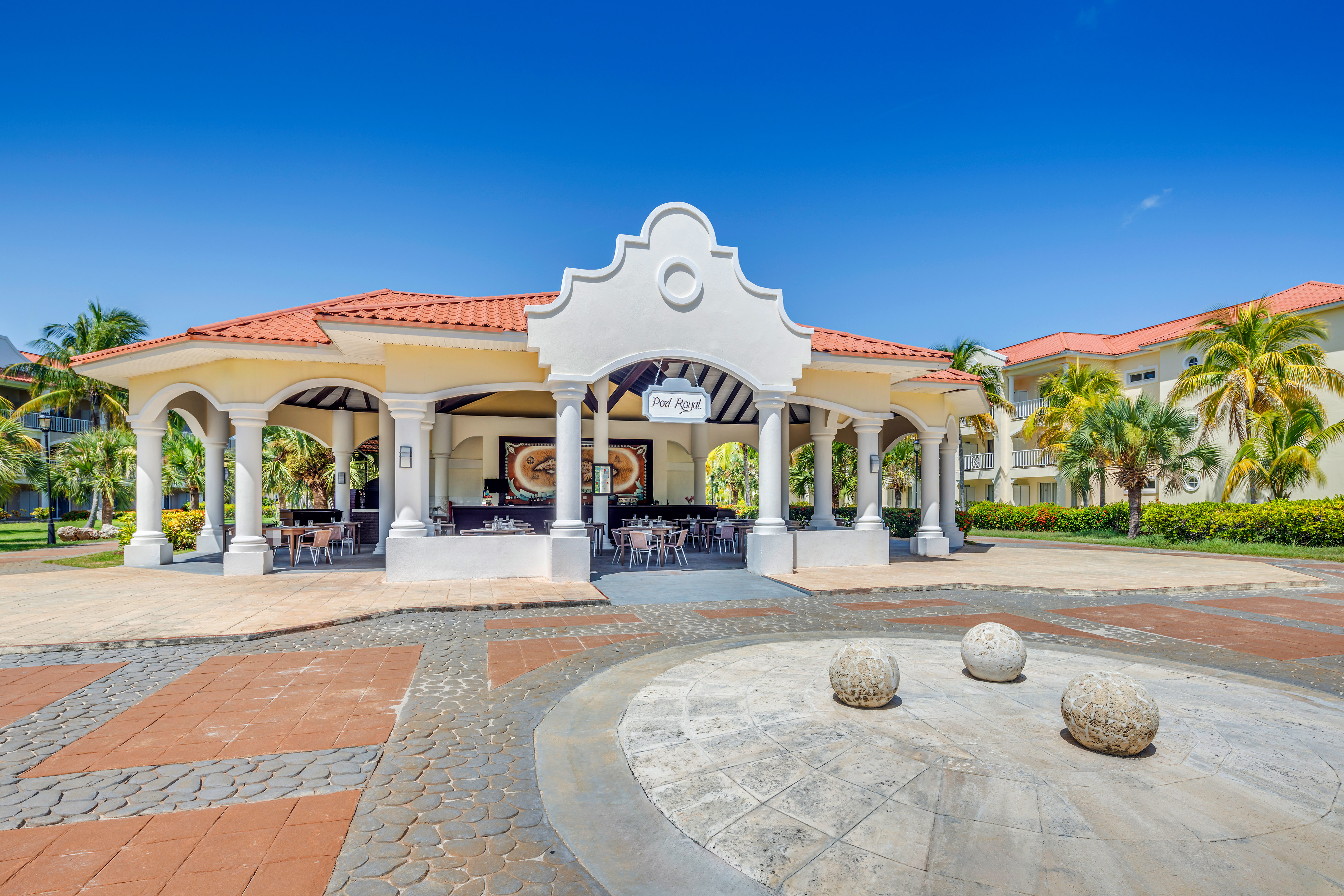 a building with columns and a round stone circle
