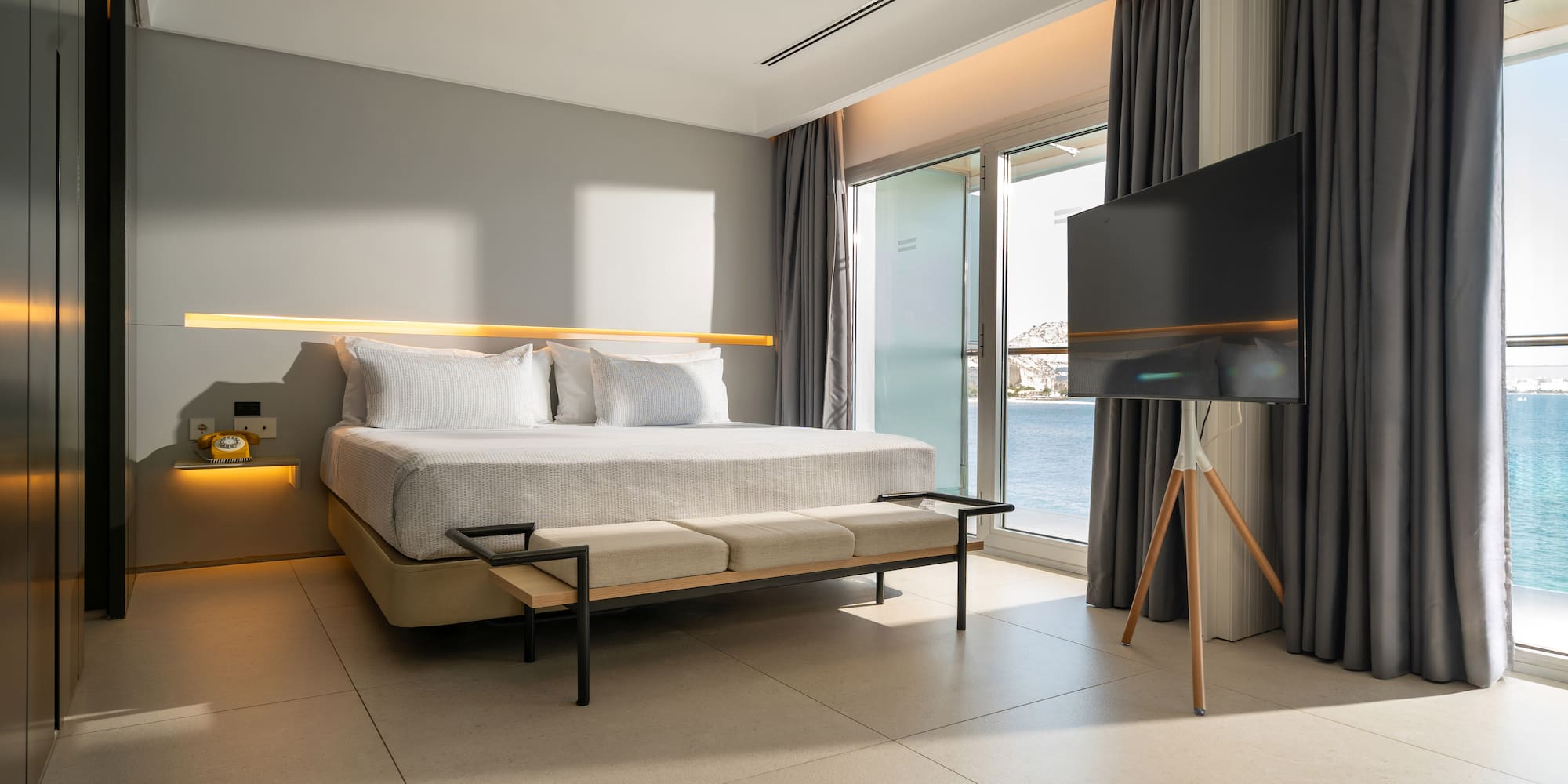 a room with a bed and a television