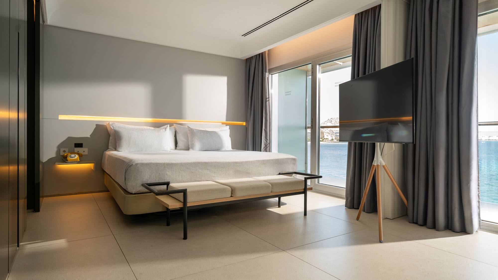 a room with a bed and a television