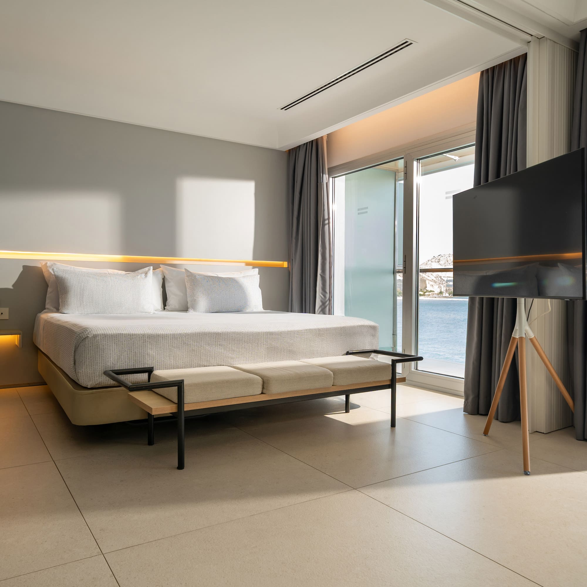 a room with a bed and a television