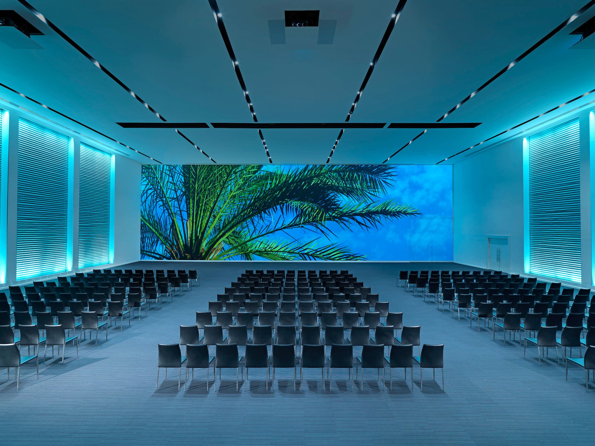 a large room with chairs and a large screen