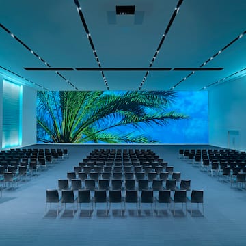 a large room with chairs and a large screen