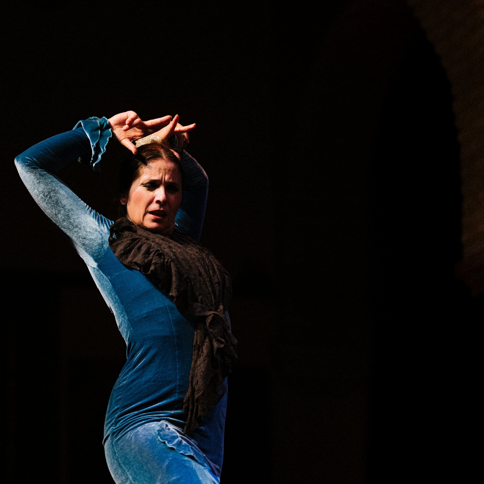 a woman dancing in a blue dress