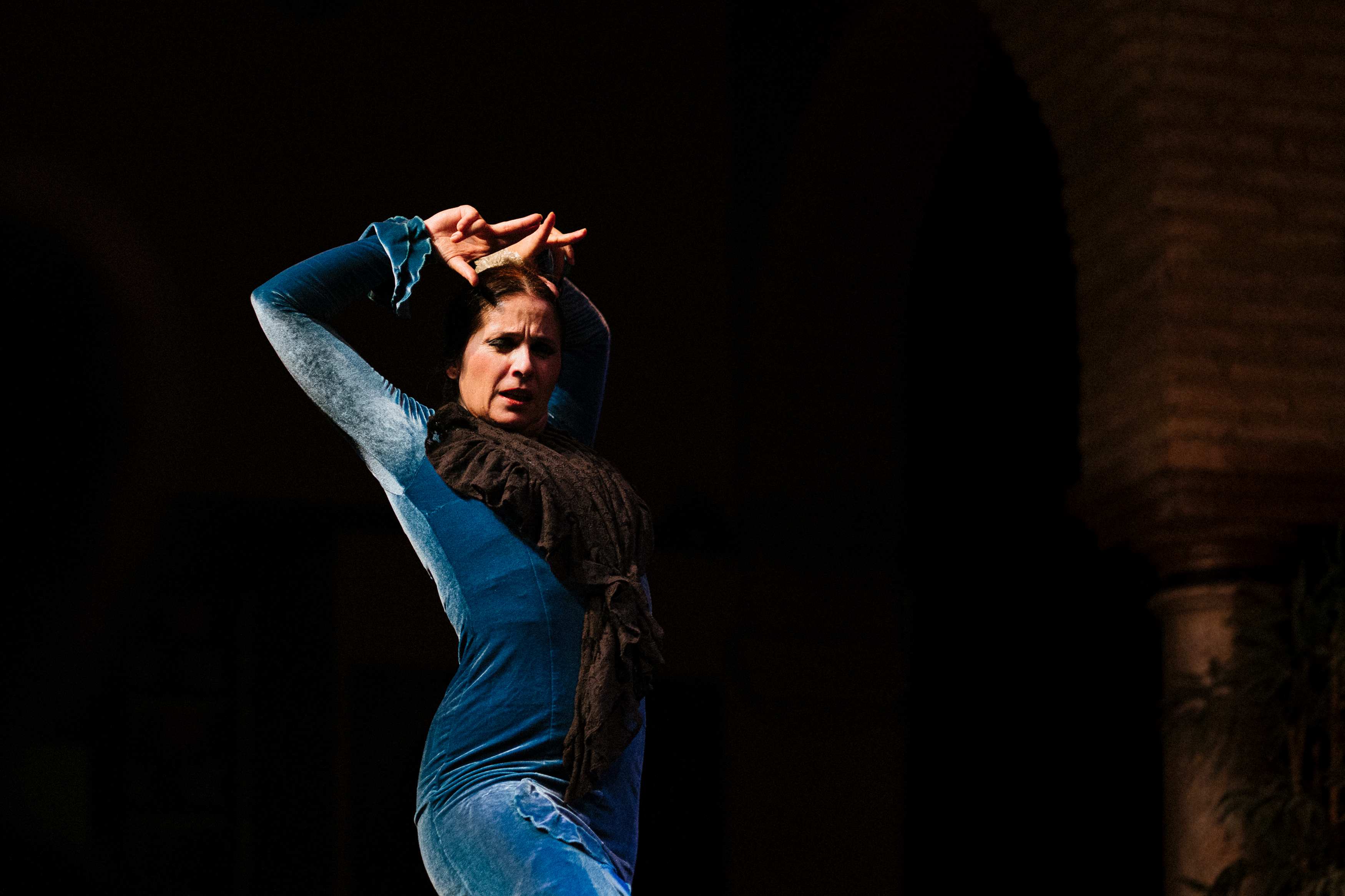 a woman dancing in a blue dress