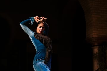 a woman dancing in a blue dress