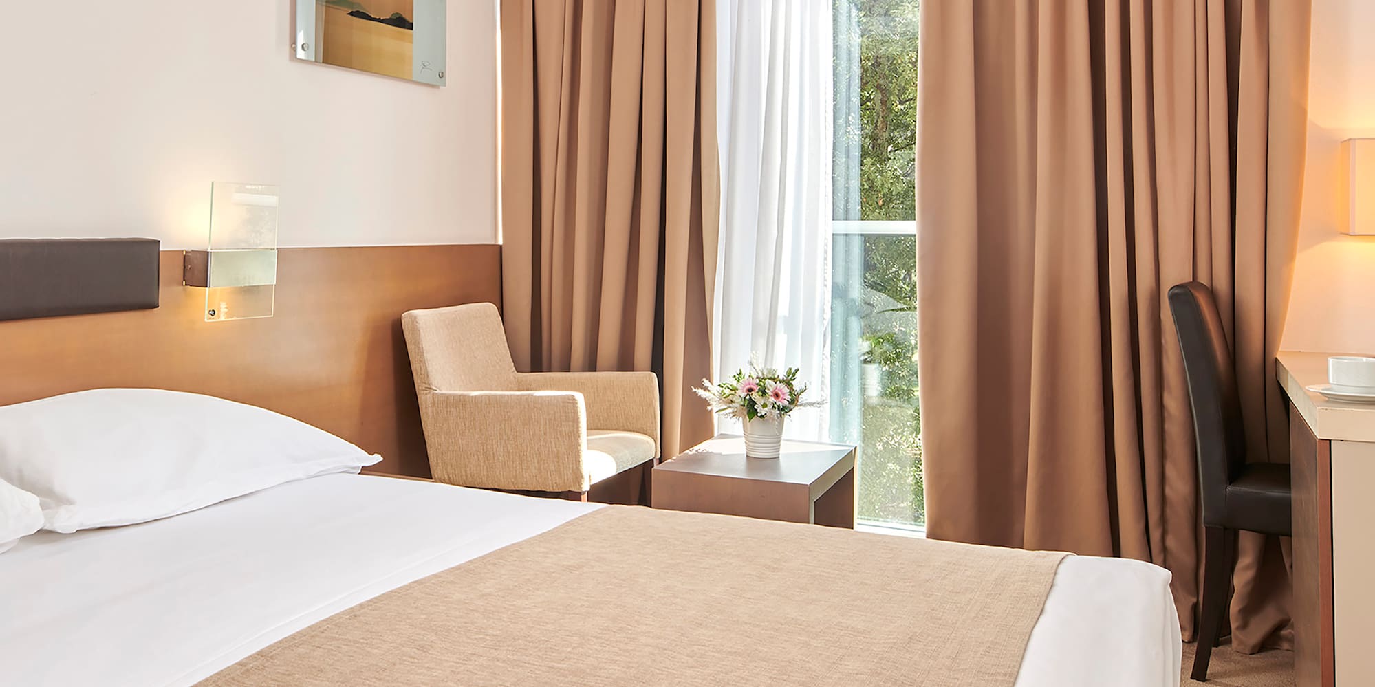 a room with a bed and a desk and chairs