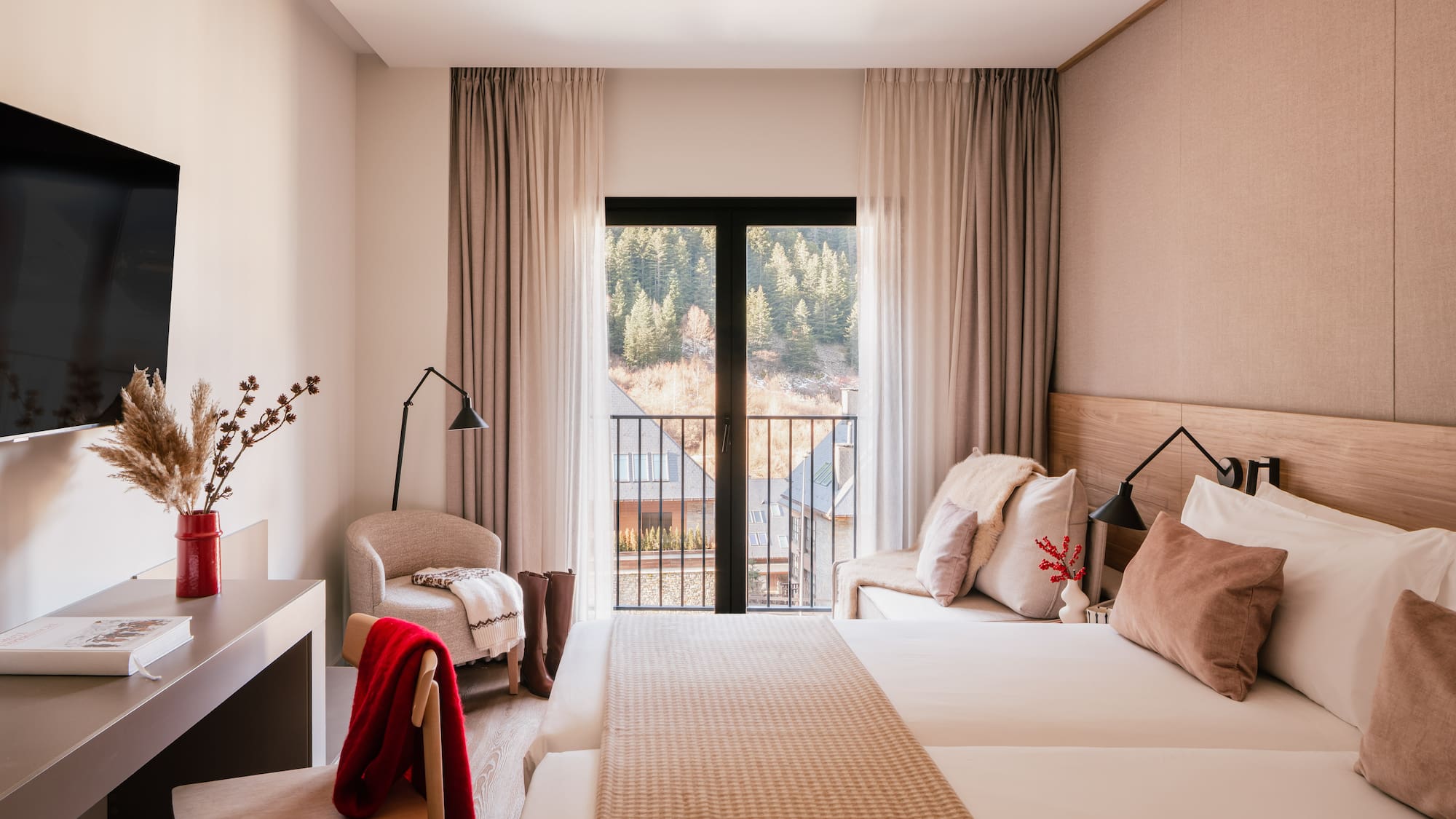 Cozy hotel bedroom with mountain view balcony, twin beds, and modern decor.
