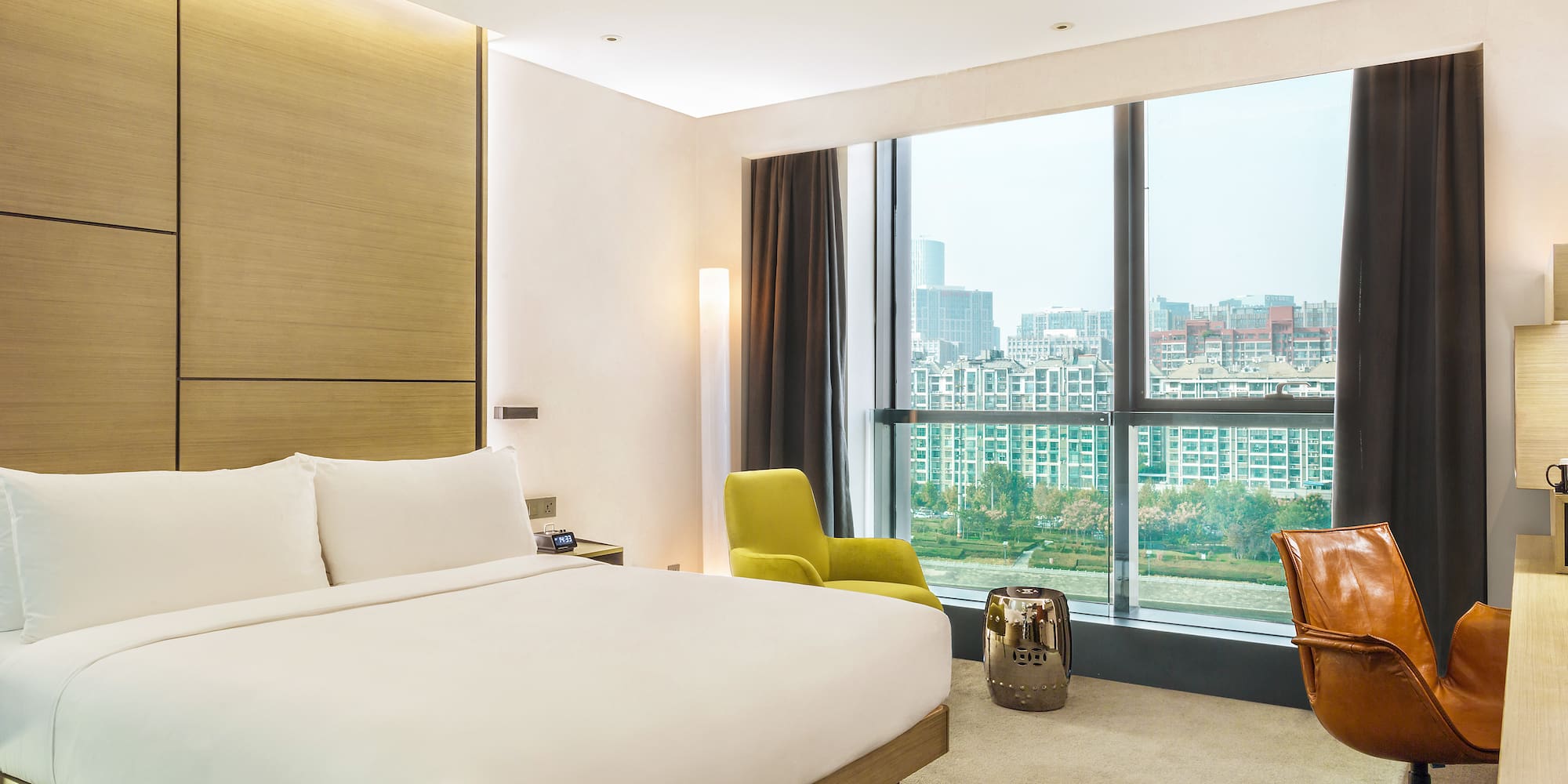 a bedroom with a large window and a large bed