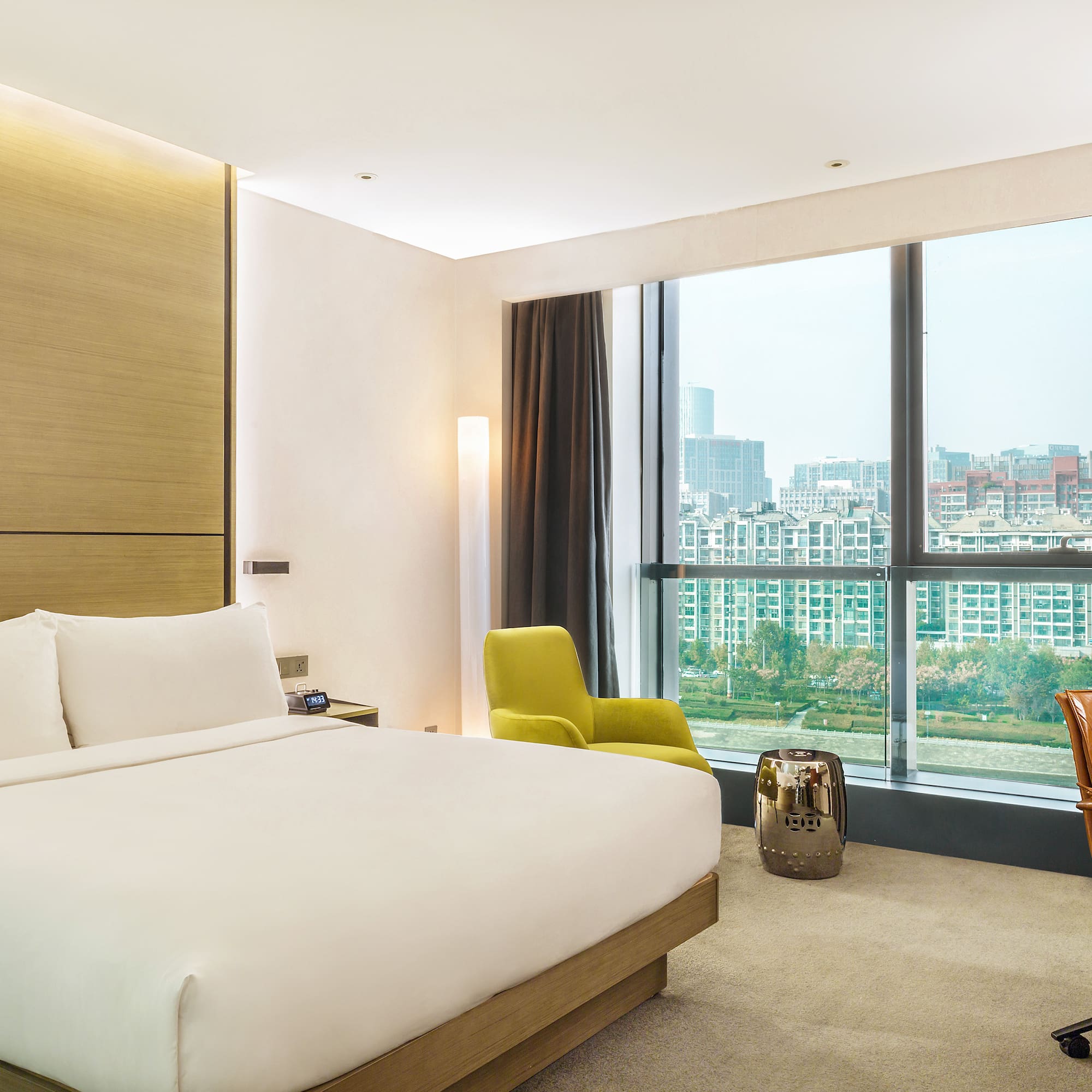 a bedroom with a large window and a large bed