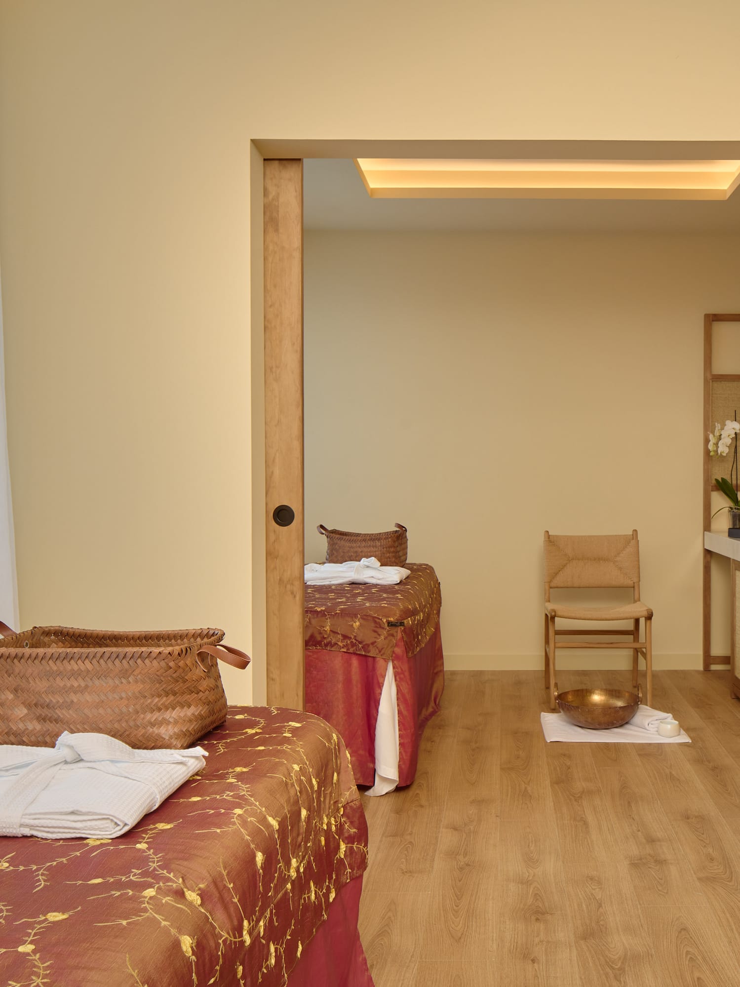 a room with two beds and a chair