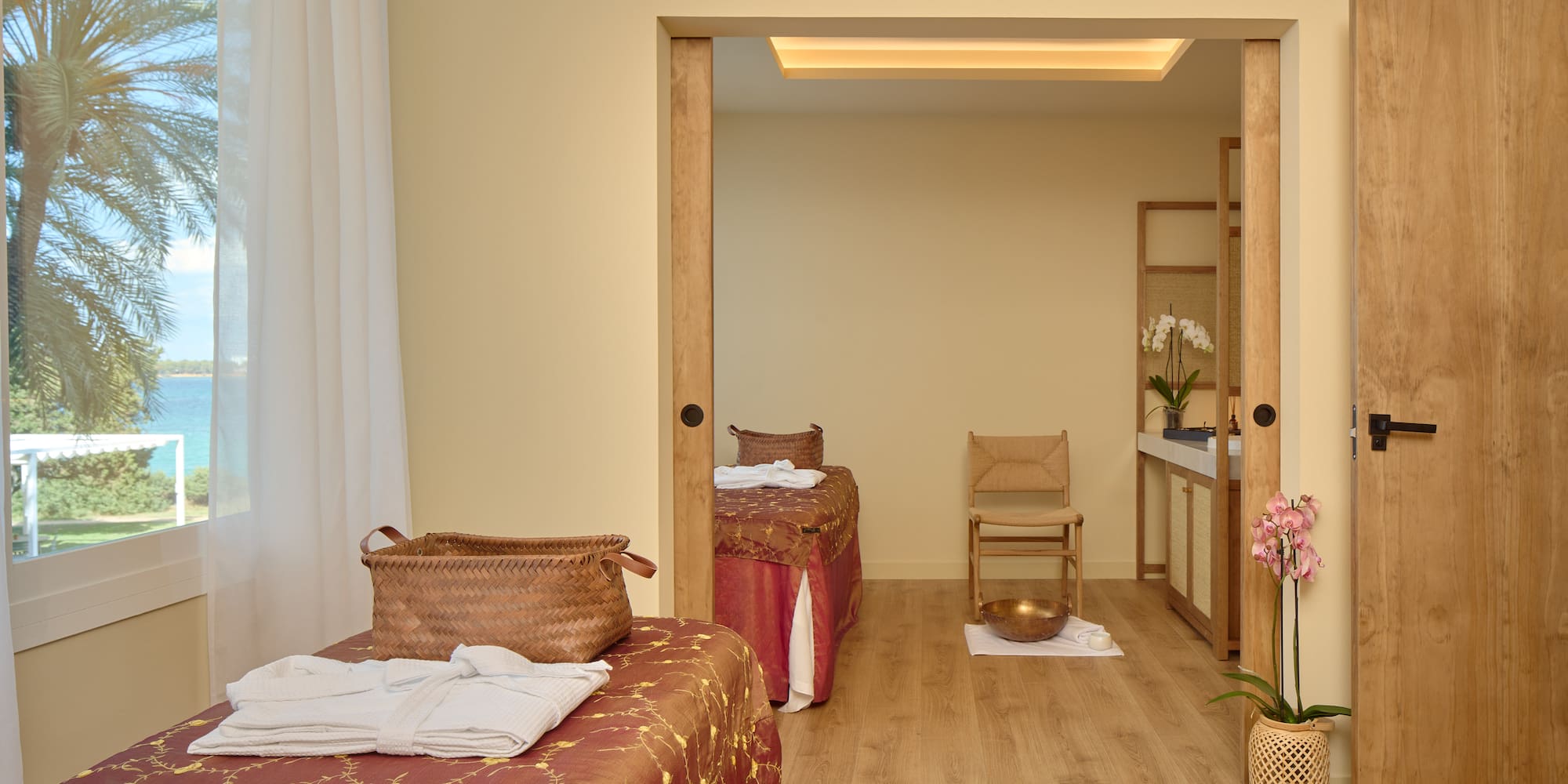 a room with two beds and a chair