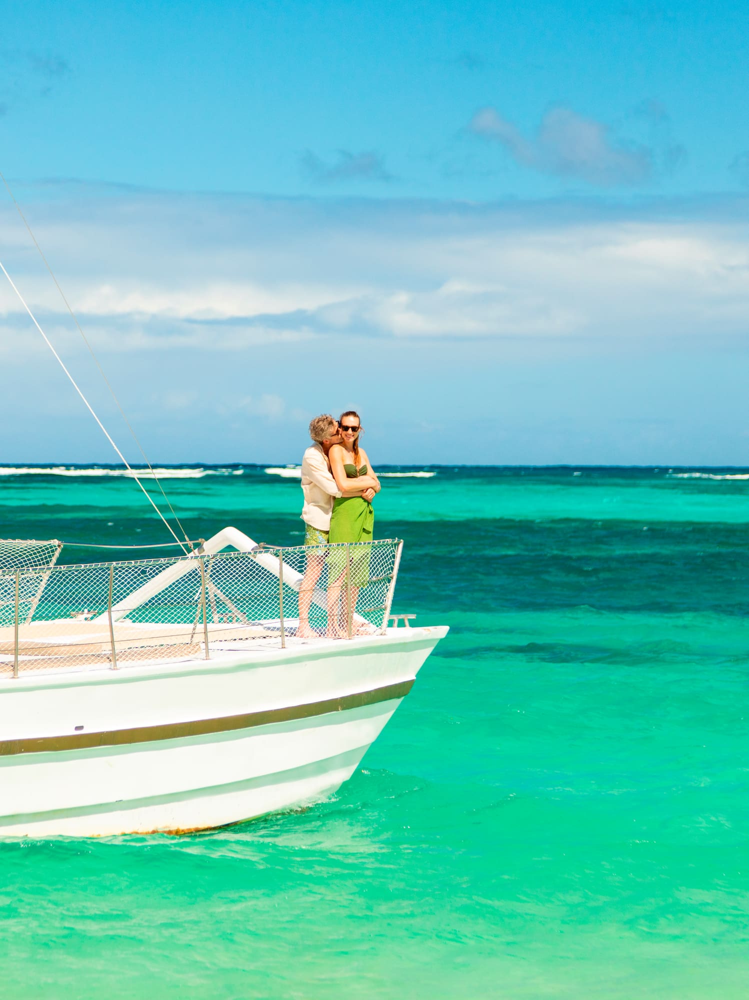 a man and woman on a boat in the ocean