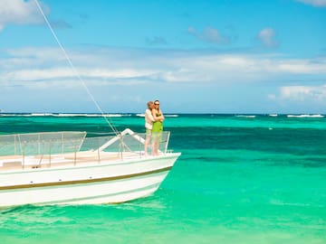 a man and woman on a boat in the ocean