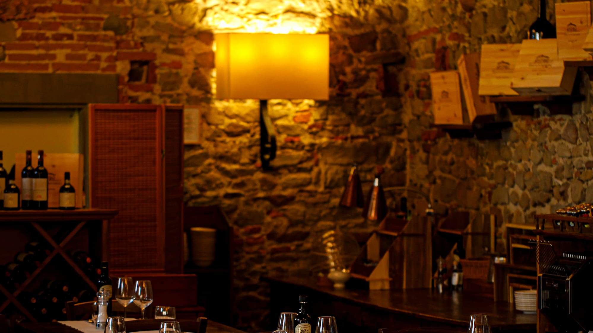 a room with tables and chairs and wine bottles