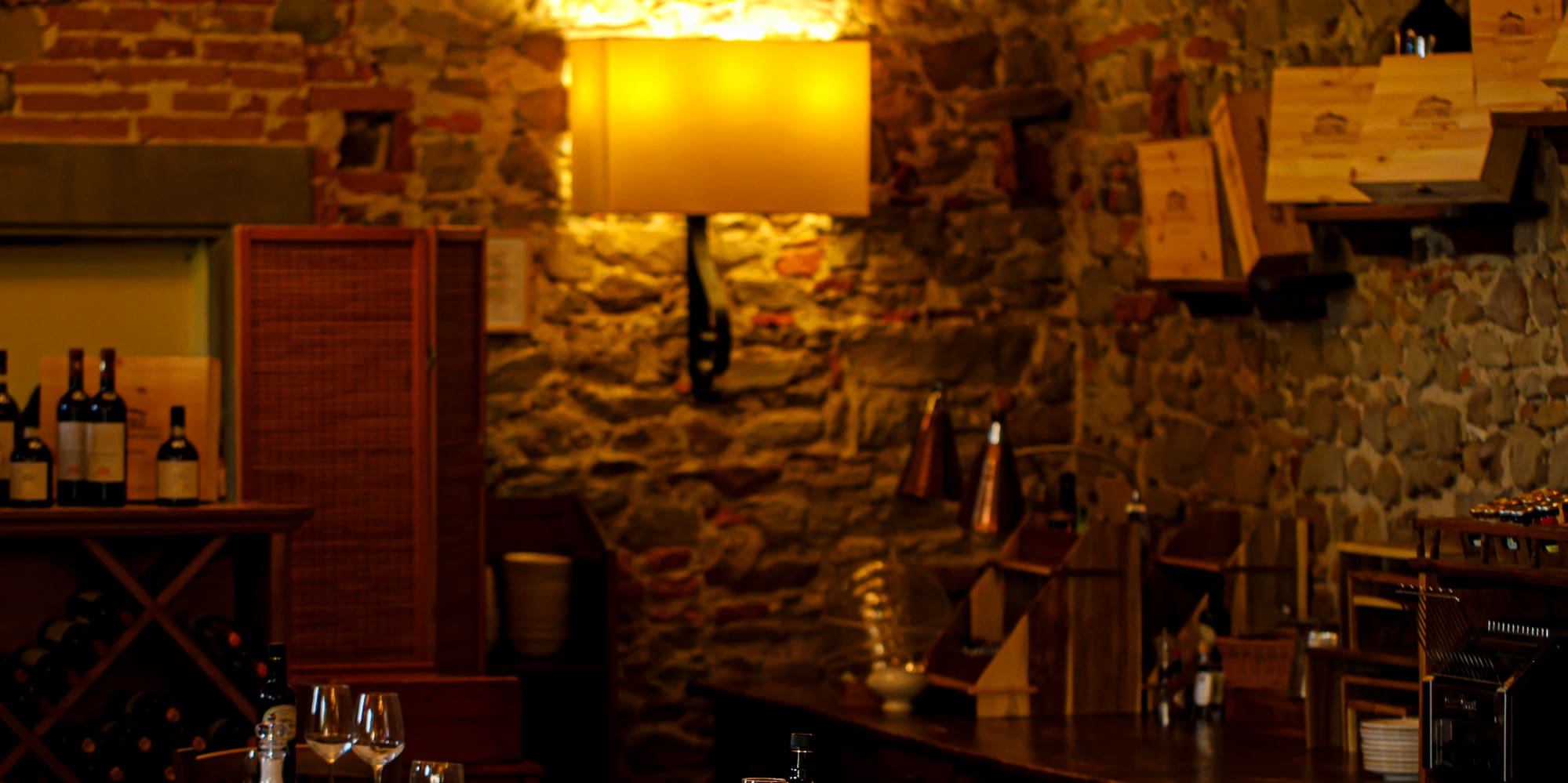 a room with tables and chairs and wine bottles